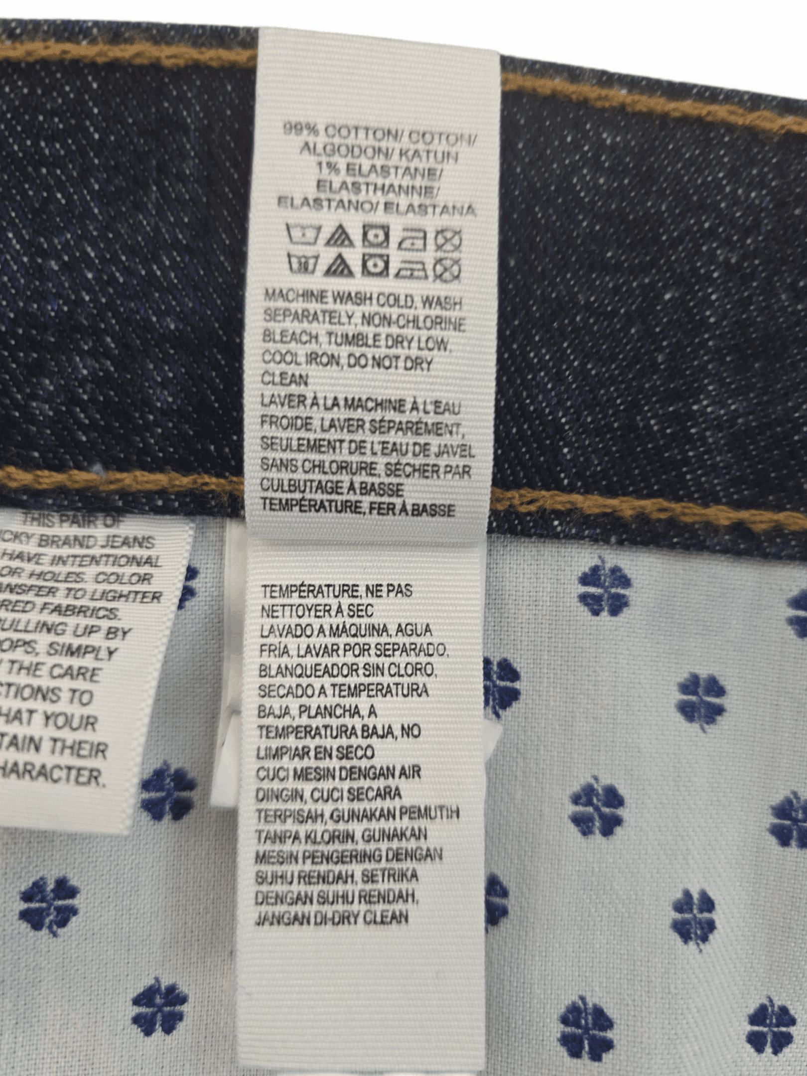 Close-up of clothing care labels with washing instructions and fabric details.