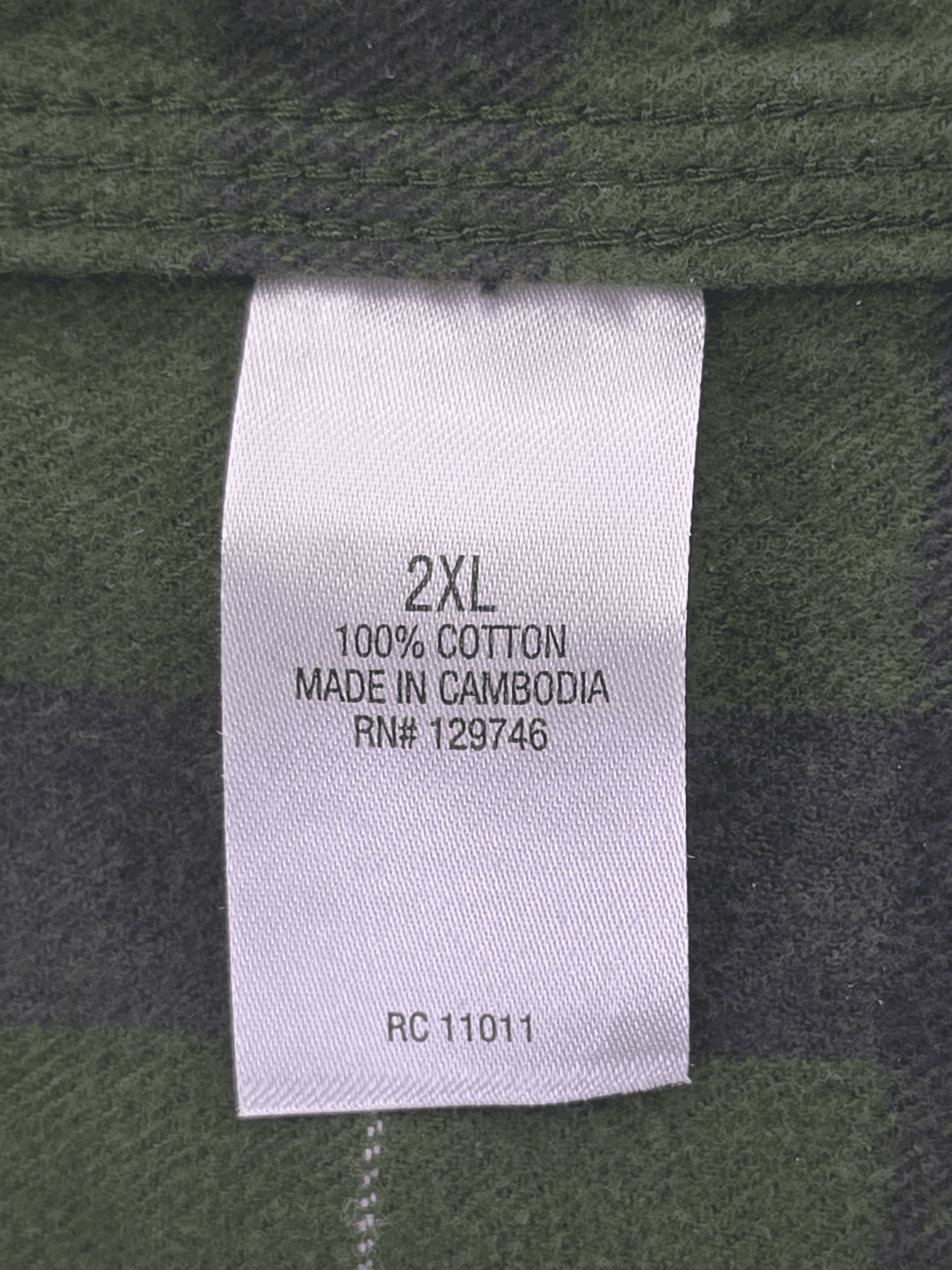 Clothing label indicating size 2XL, 100% cotton, made in Cambodia.