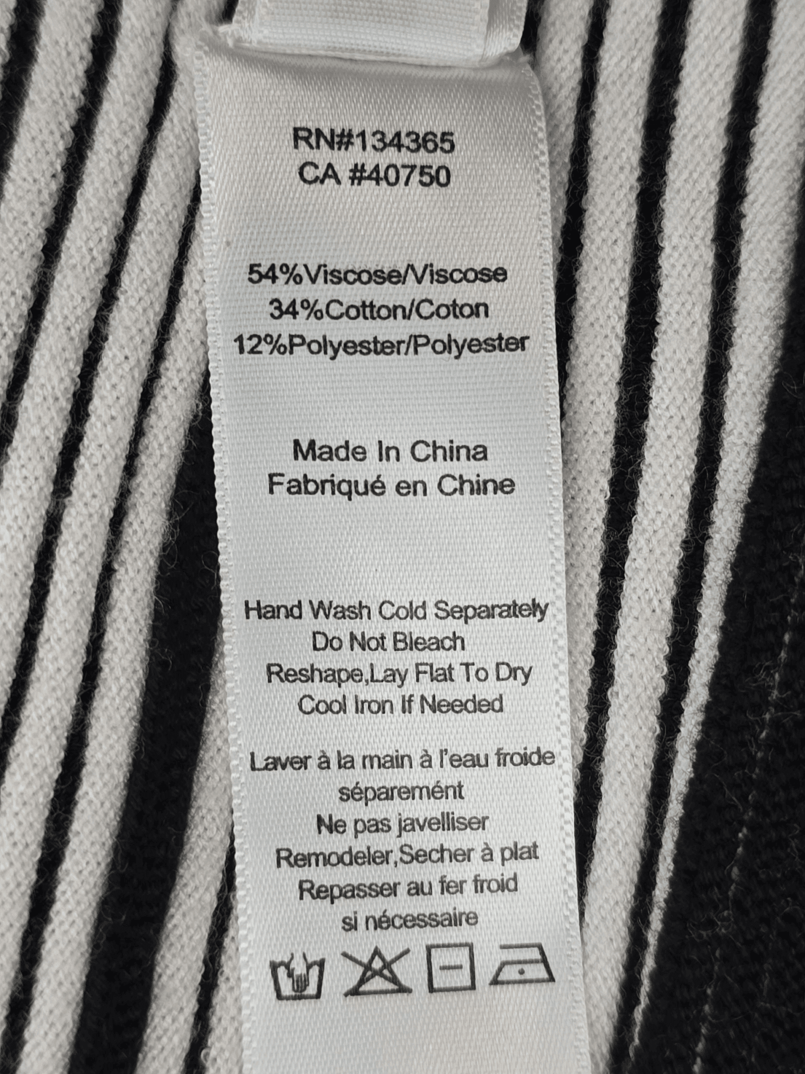 Fabric content tag from Marla Wynne black and white ribbed short sleeve wrap sweater women’s plus size 2X/3X