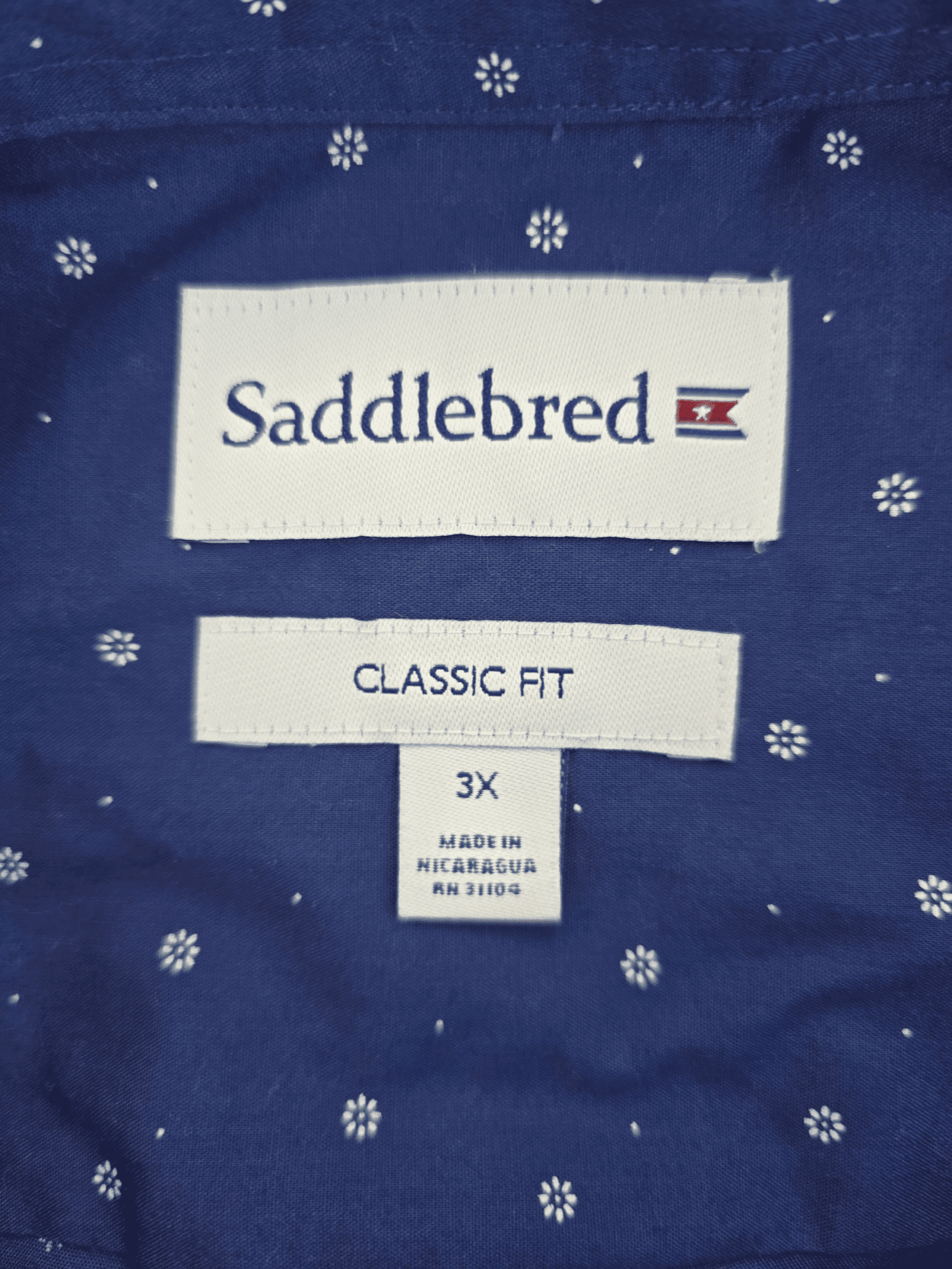 Saddlebred brand and size tag on blue classic fit short sleeve button-up shirt in men’s size 3X.