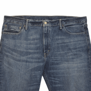 Close-up of Levi’s 511 men’s blue straight leg jeans showing button, zipper, and denim texture.