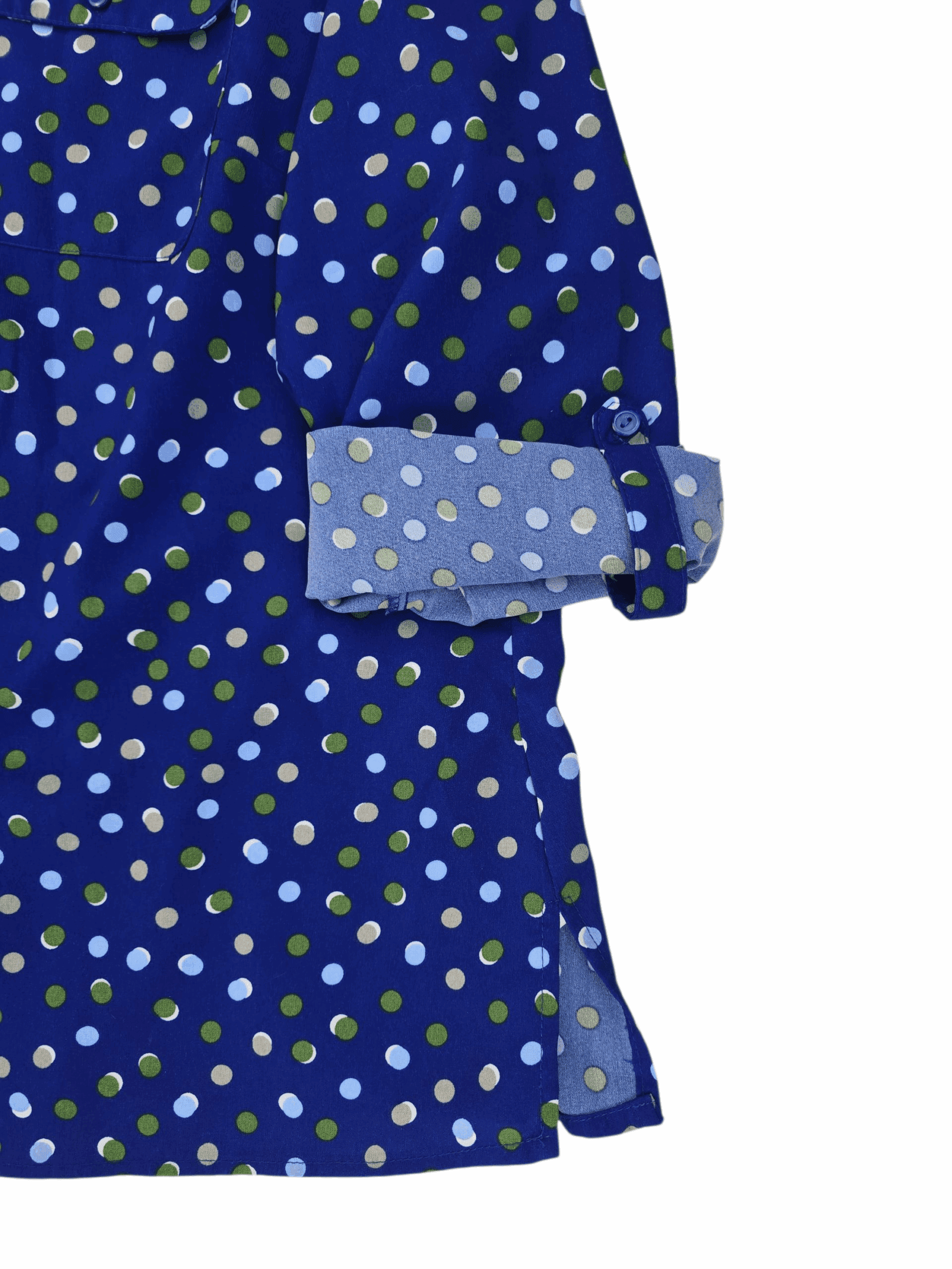 Close-up of Kim Rogers blue polka dot V-neck long sleeve top sleeve showing rolled-up cuff secured with a button roll tab.