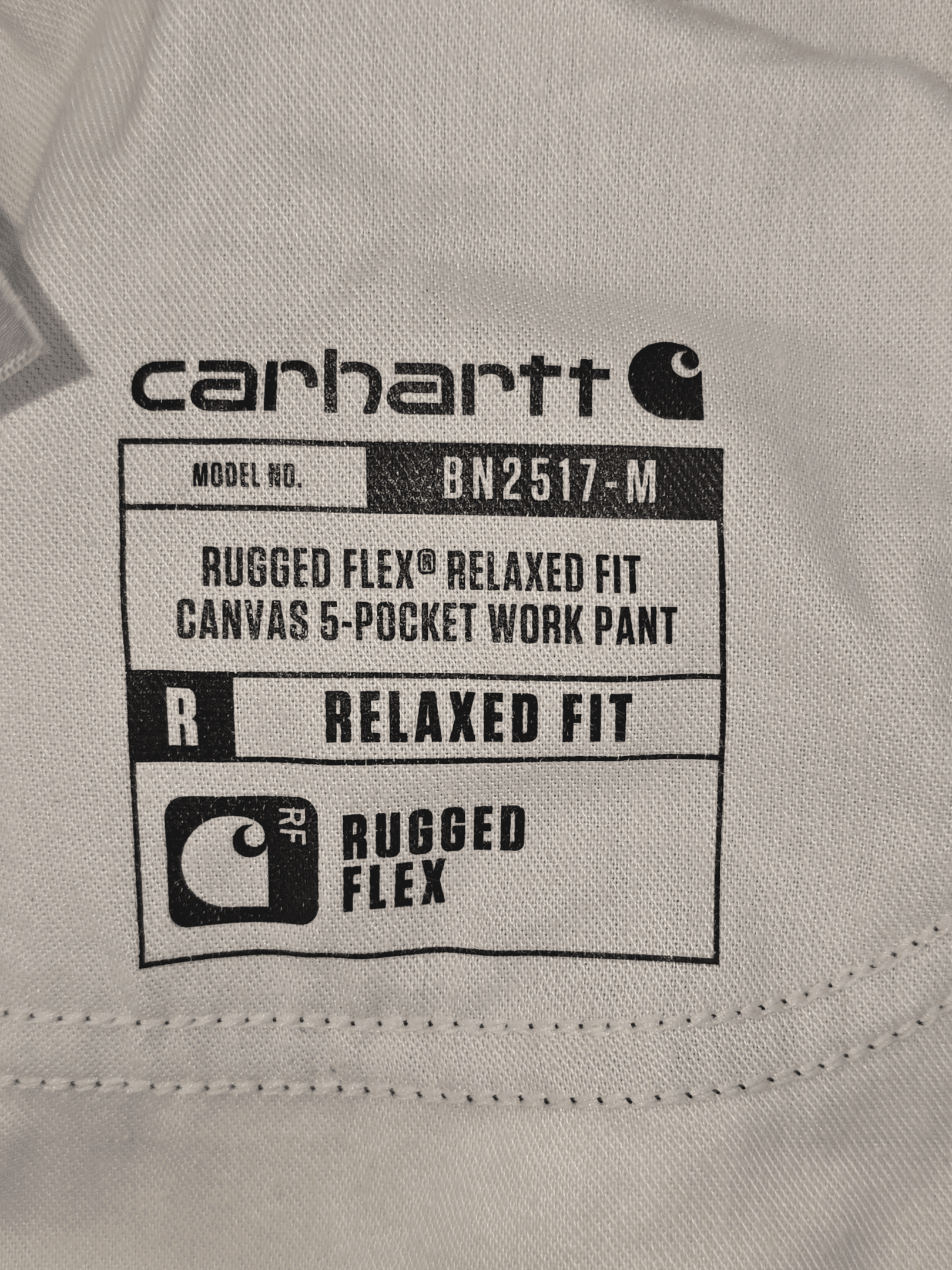 Label of Carhartt Rugged Flex Relaxed Fit Canvas Pocket Work Pant.