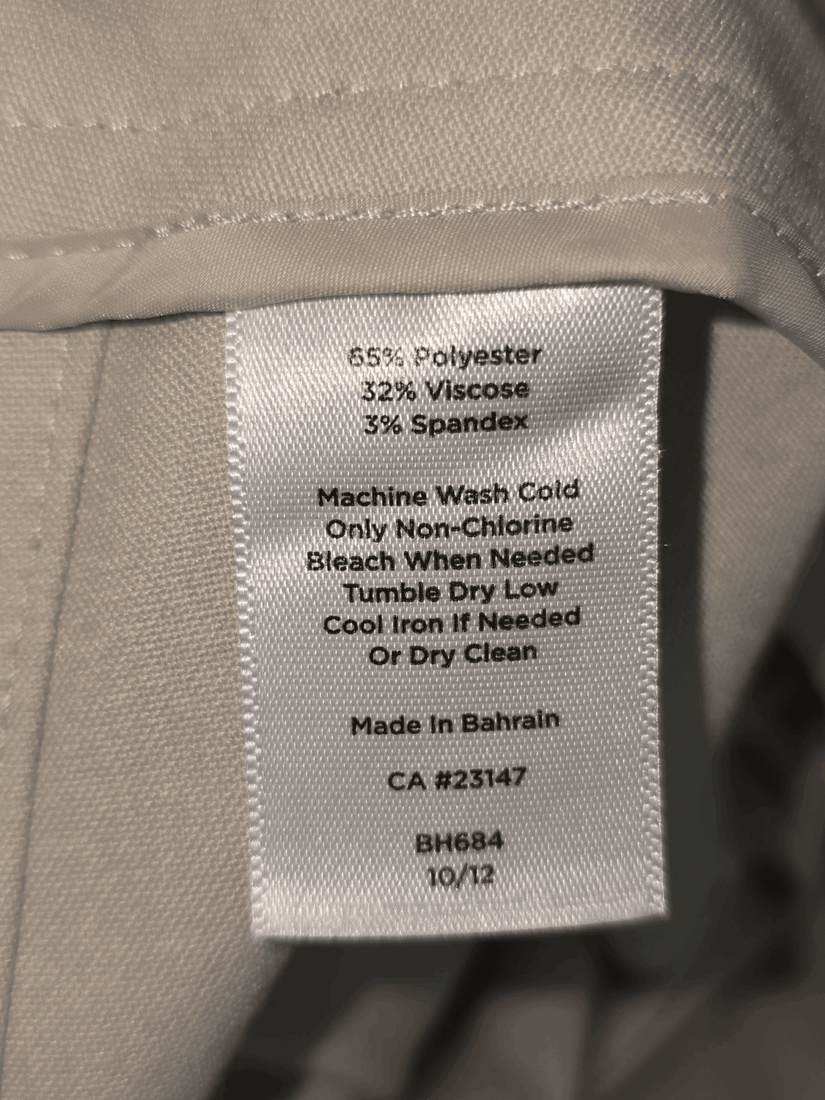 Clothing label detailing fabric content and care instructions for a nylon-wash outfit.