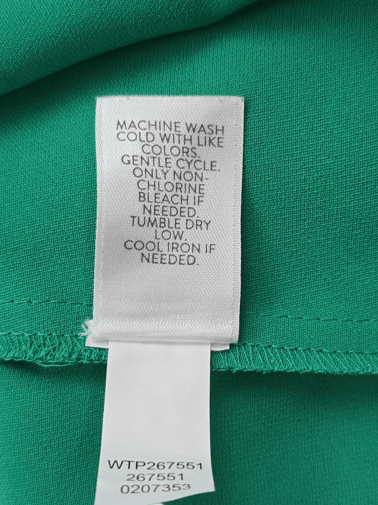 Garment care tag for J. Jill Wearever Collection green pullover top showing washing and drying directions.