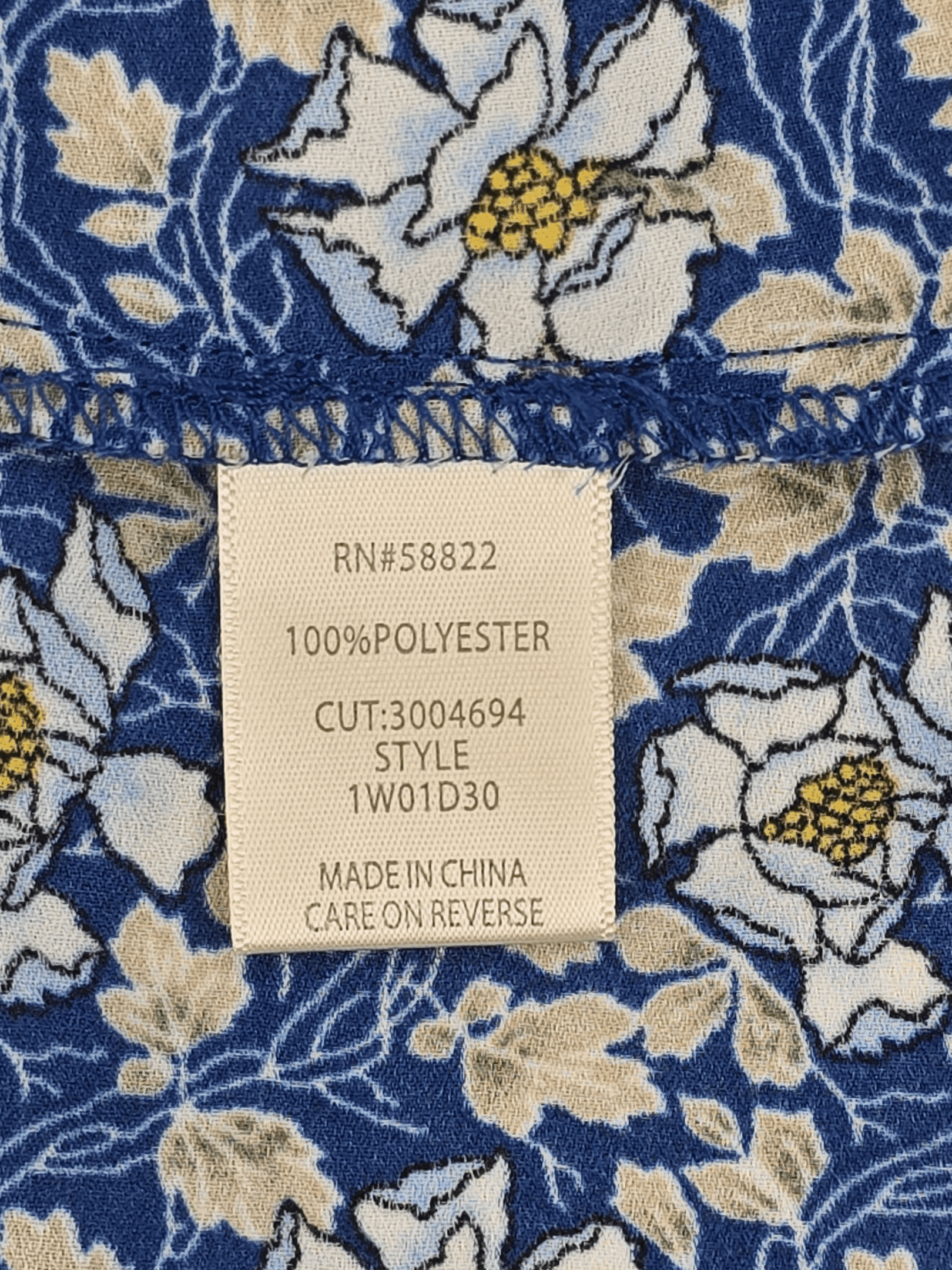 Clothing label showing material and manufacturing details.