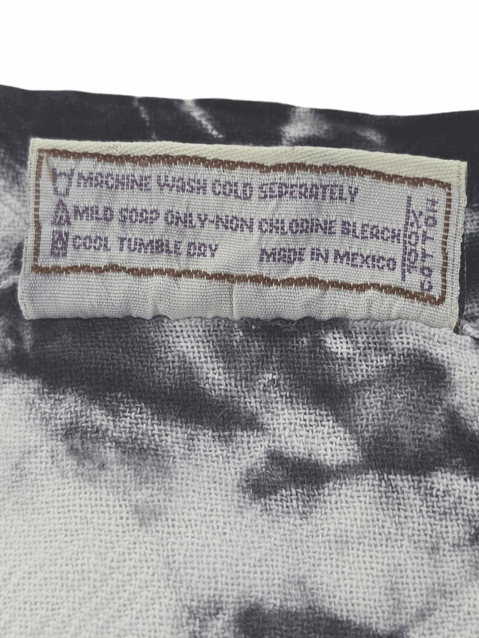Garment care instruction tag from Cottonways black & white tie-dye pullover top size 2X