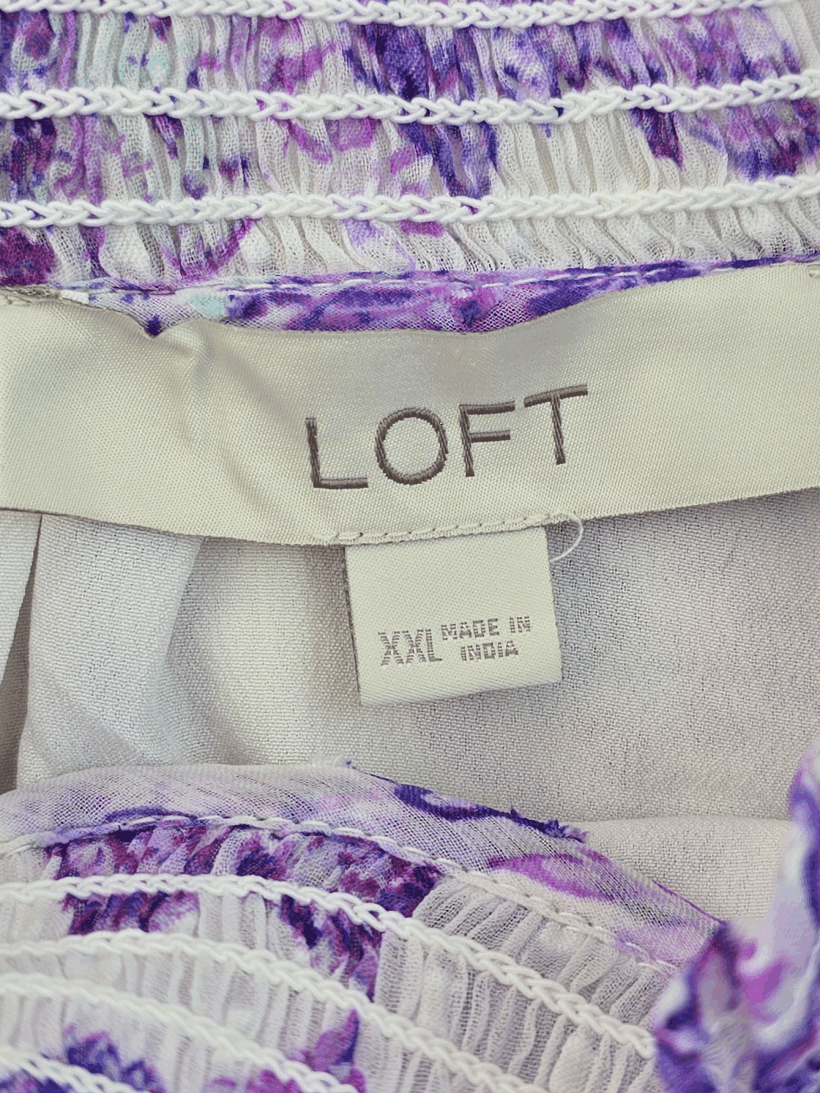 Clothing label showing brand 'LOFT' and size XXL made in China.