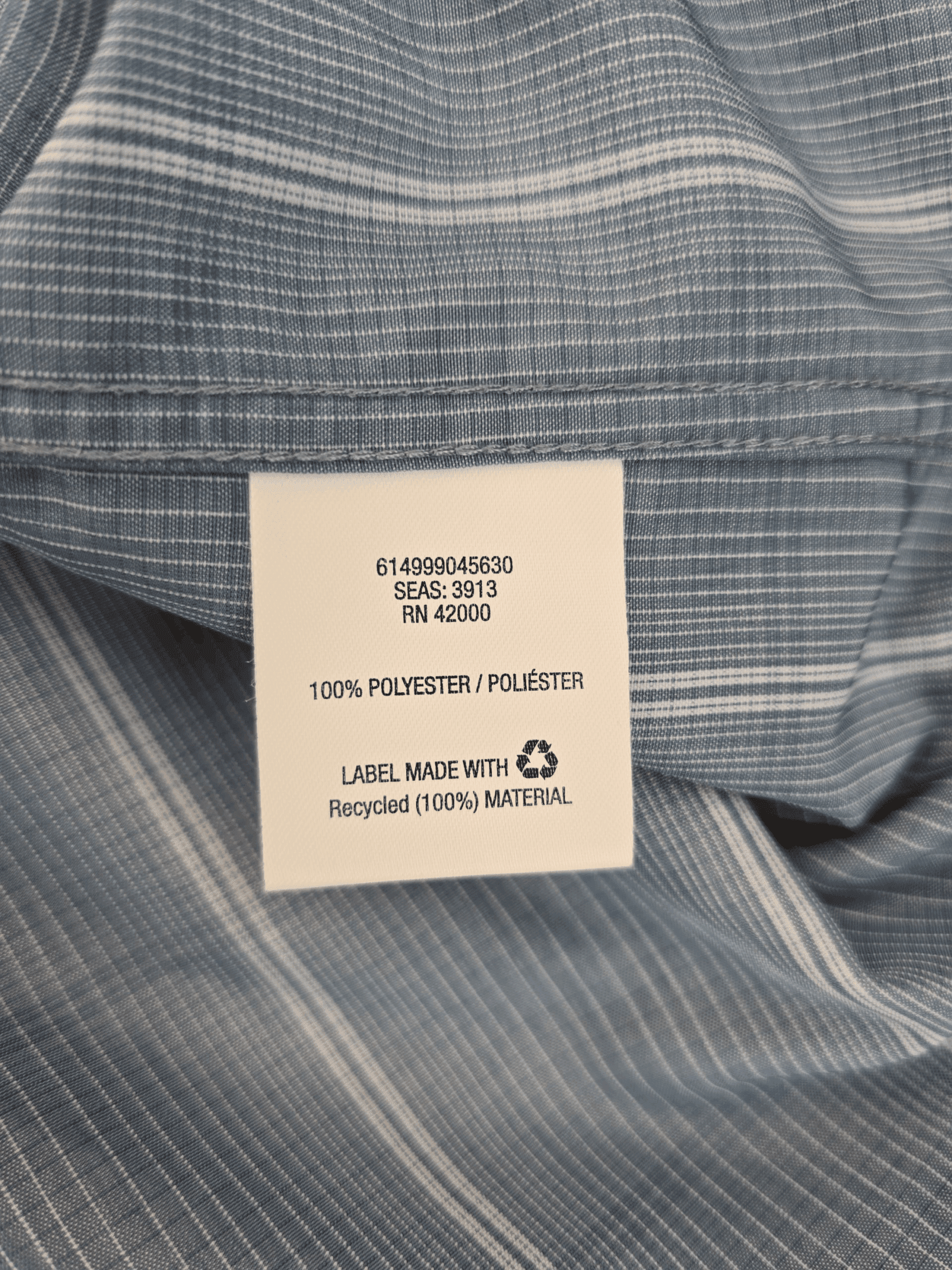 Material content tag listing 100% polyester microfiber for David Taylor blue and white checked button-up shirt.