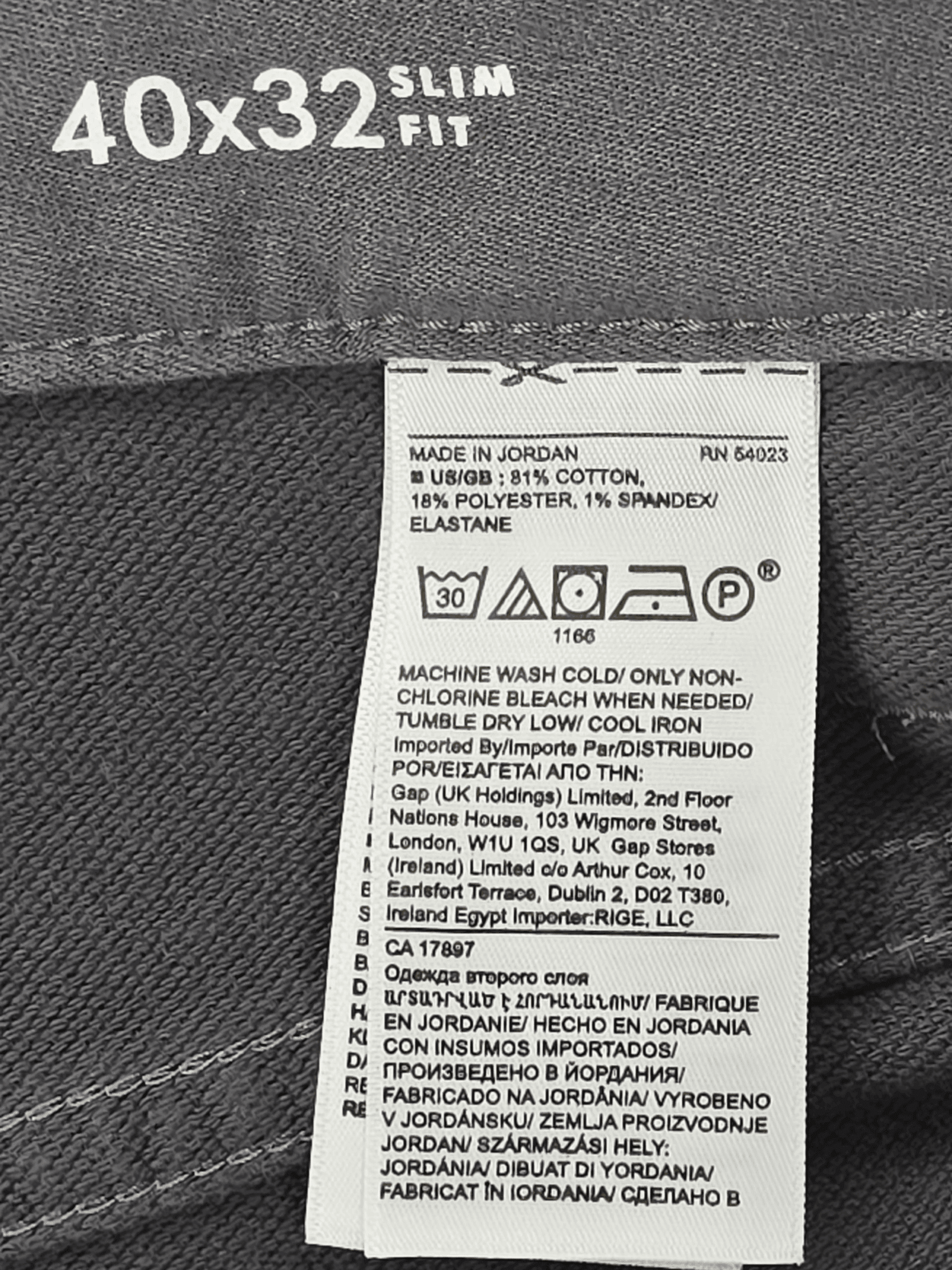Clothing care label with washing and ironing instructions on fabric.