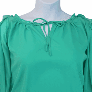 Close-up of neckline, gold detail, and shoulder cutouts on Cato green cold shoulder blouse women’s size 22/24W