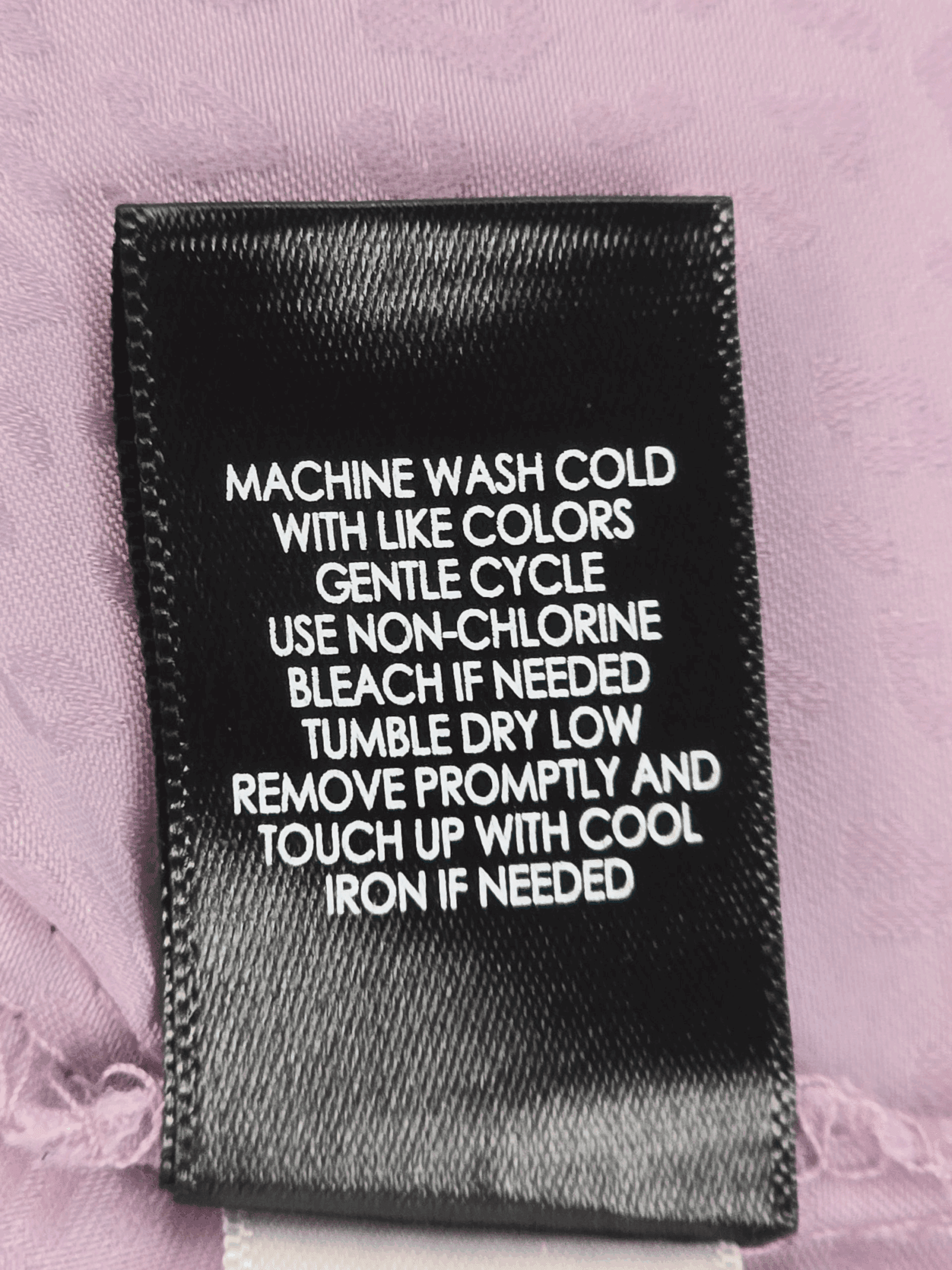 Garment care instruction tag from Torrid Sophie purple animal print adjustable spaghetti strap top women’s plus size 2X