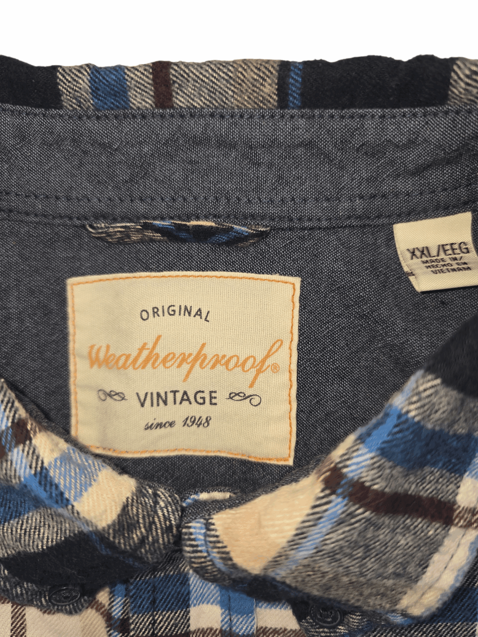 Close-up of a plaid shirt label showing 'Weatherproof Vintage'.