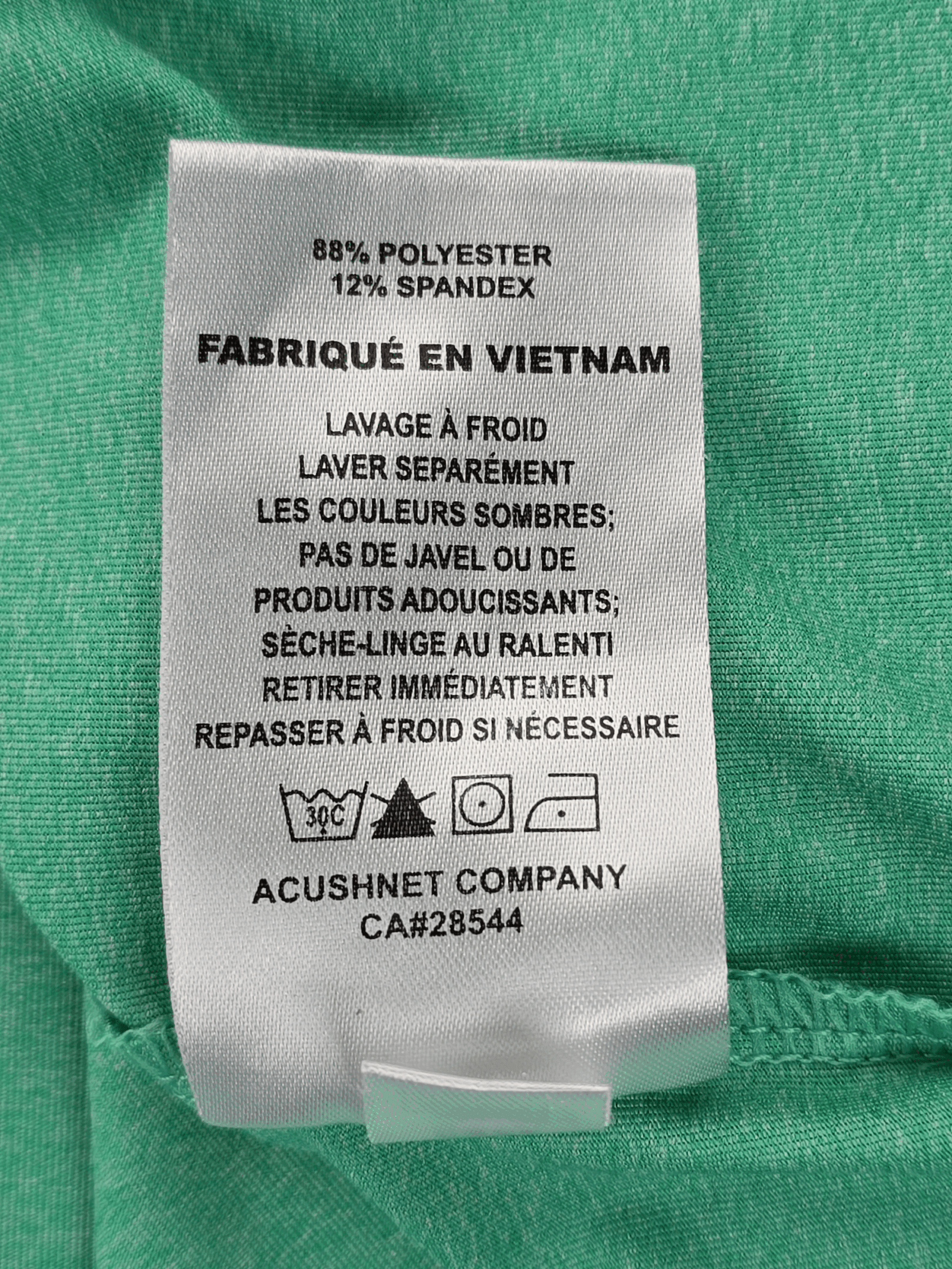 Clothing label with fabric composition and care instructions in French, made in Vietnam.