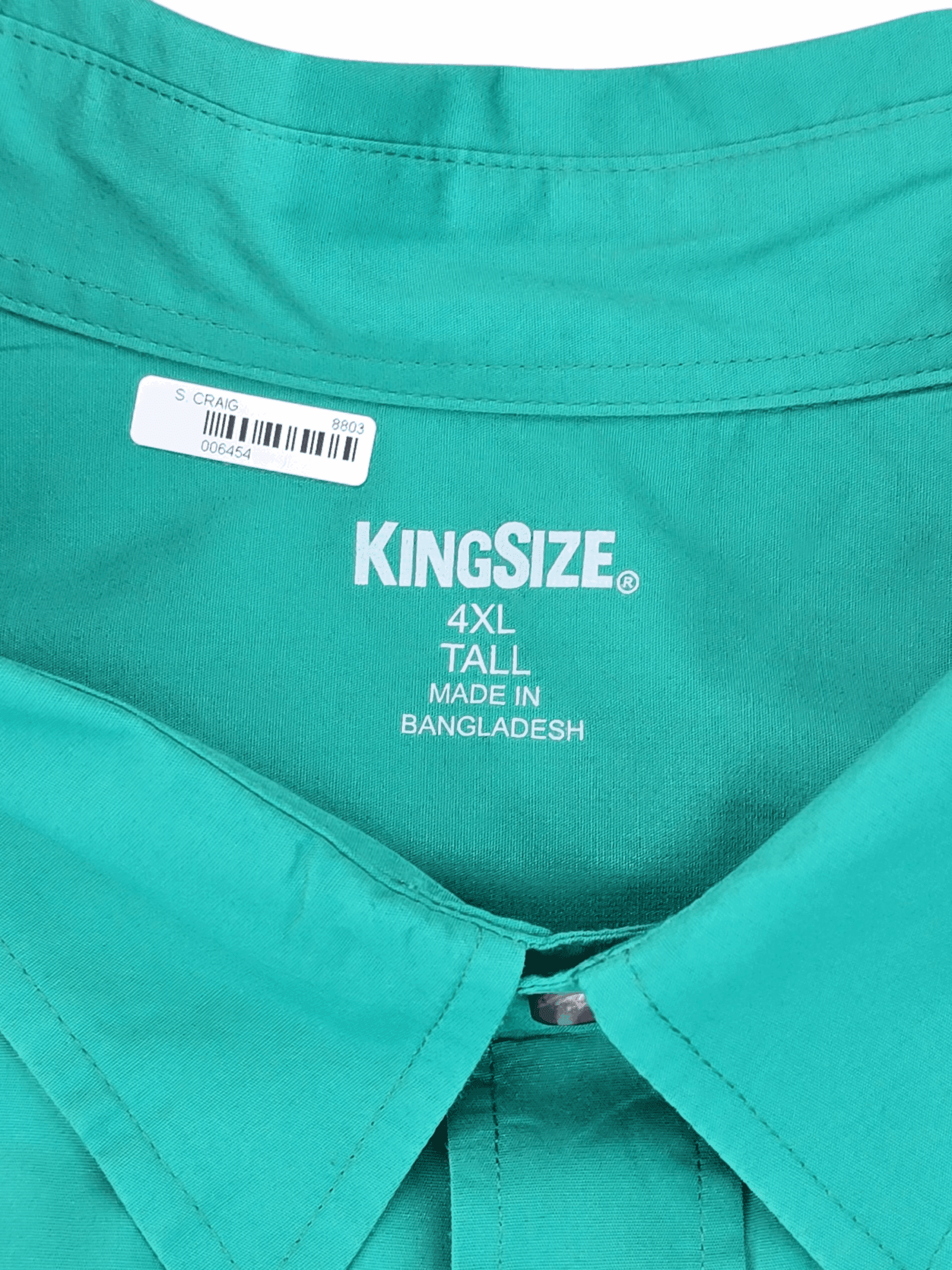 Close-up of a green KingSize XXL shirt label with size and origin details.
