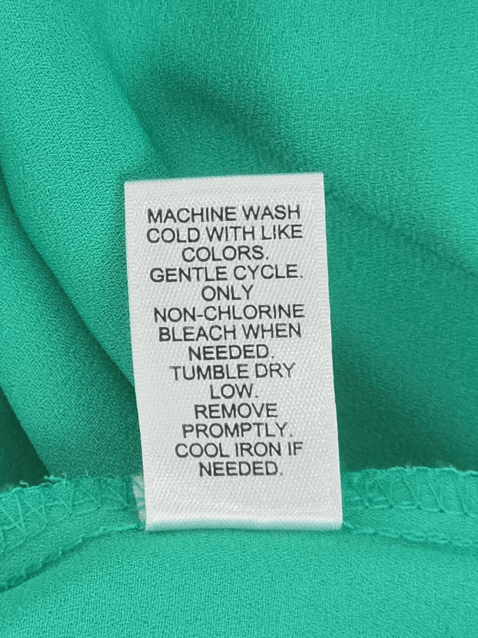 Cato green keyhole neck cold shoulder blouse care instructions label