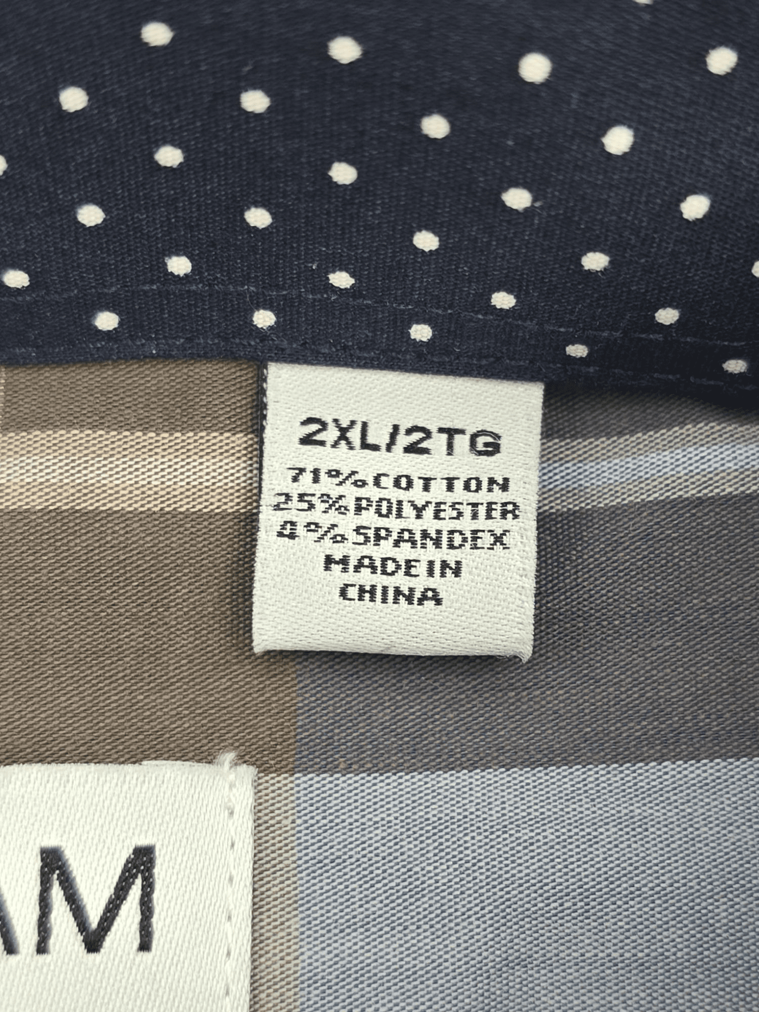 Material content tag listing cotton and spandex blend for Nick Graham “Everywhere Stretch” navy and brown plaid shirt.