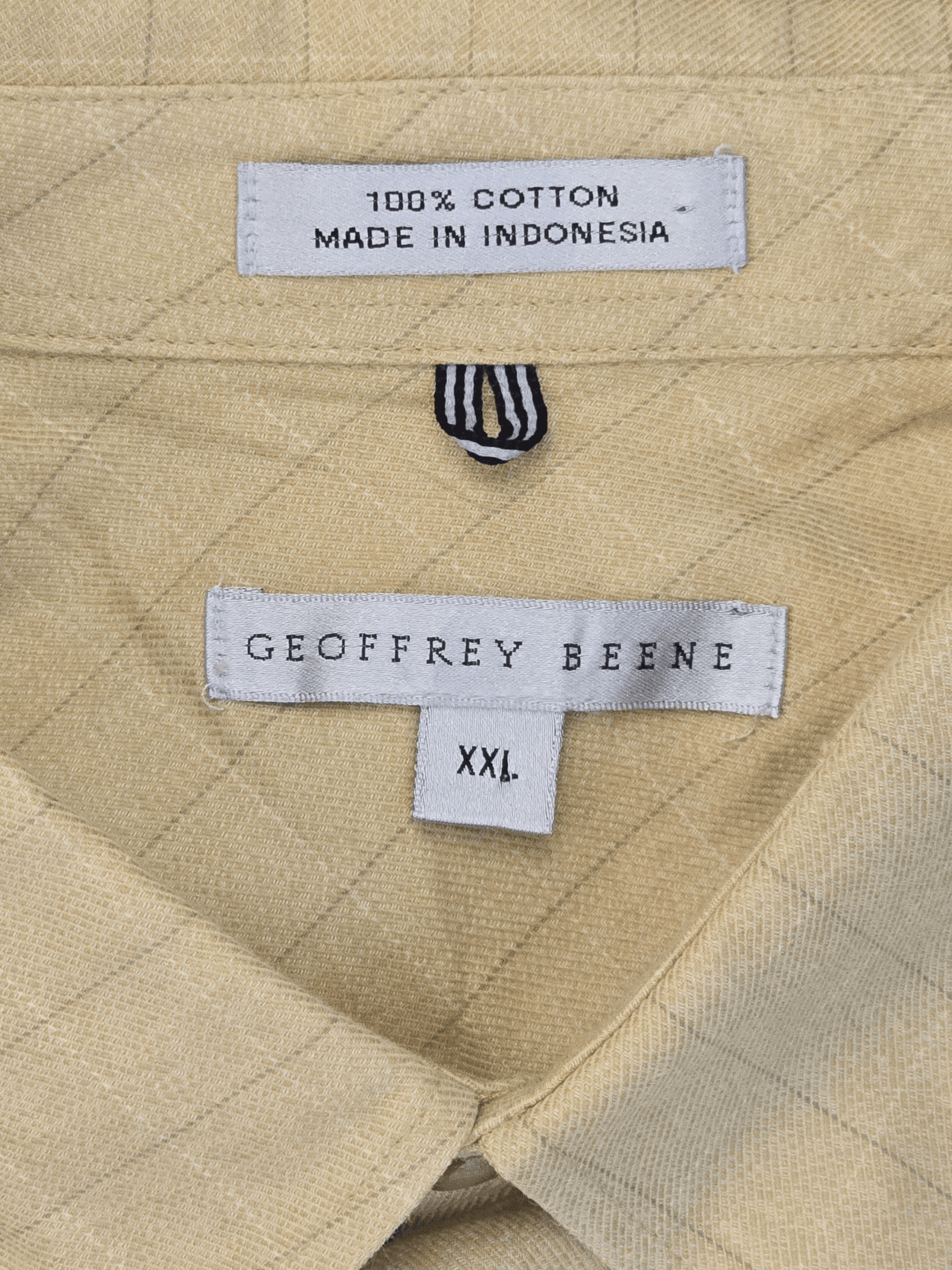 Geoffrey Beene brand and size tag on yellow striped button-up shirt in men’s size XXL.