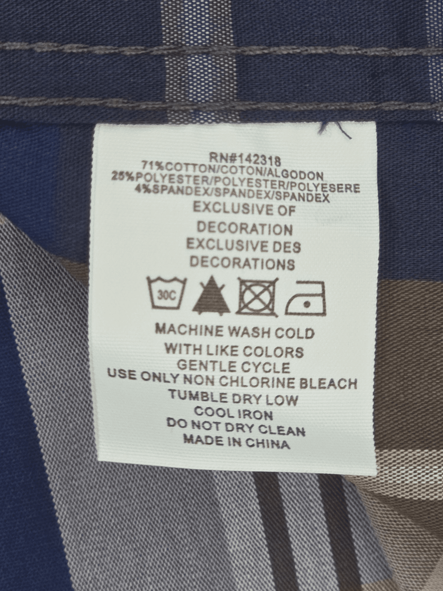 Garment care tag for Nick Graham “Everywhere Stretch” navy and brown plaid shirt showing washing and drying directions.