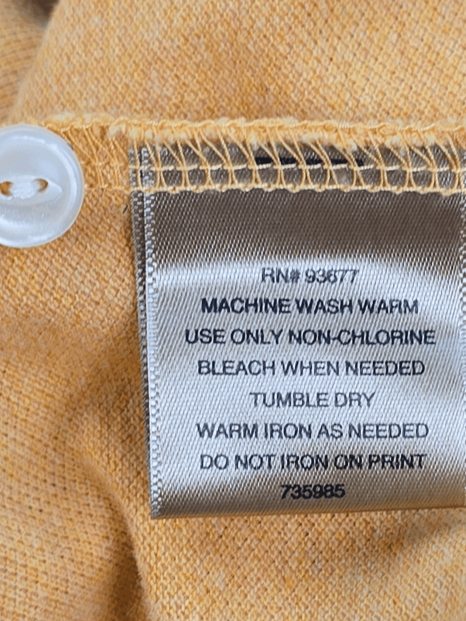 Garment care instruction tag from The Foundry bright yellow polo shirt men’s big & tall size 4X