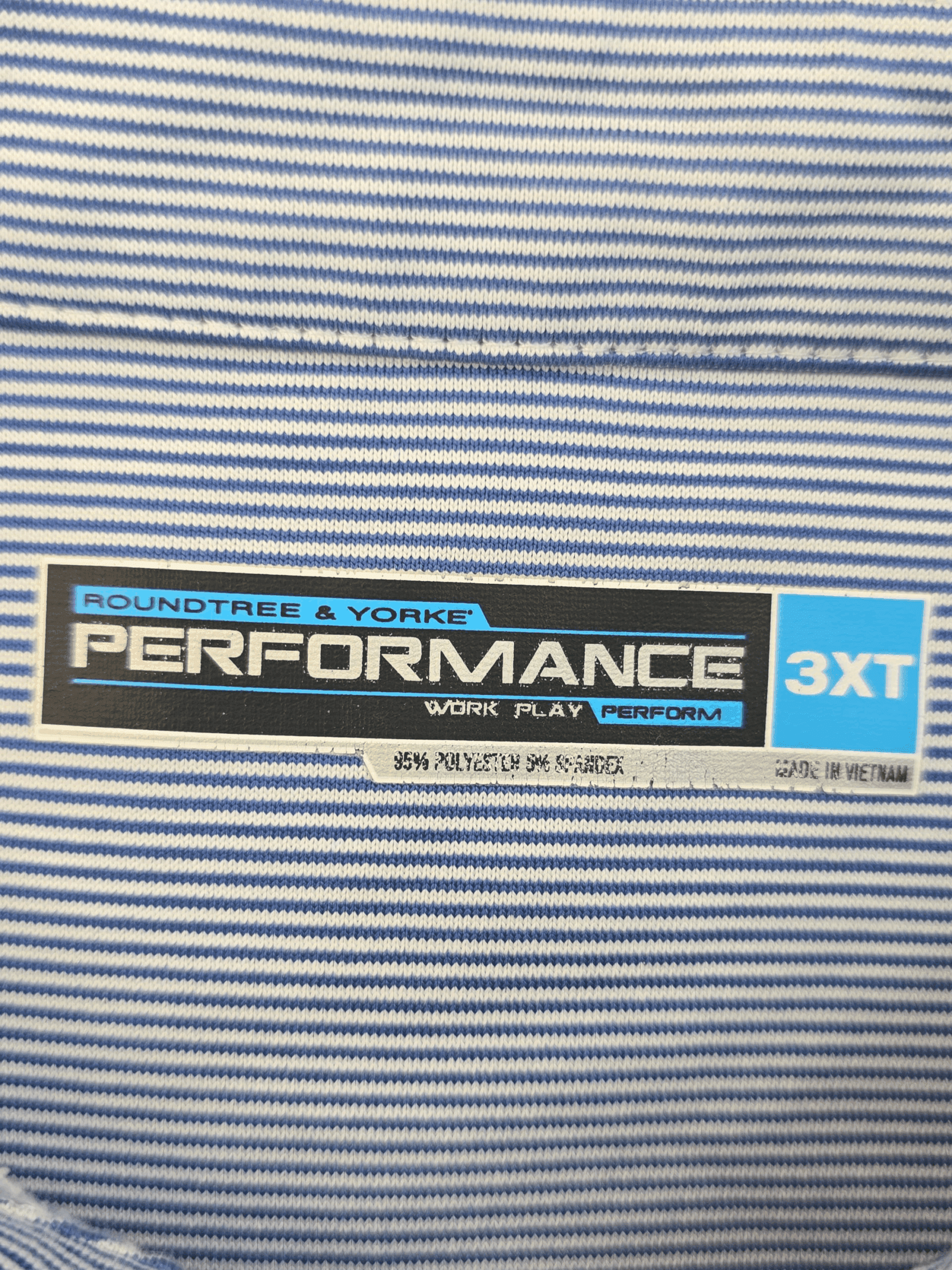 Close-up of a clothing label on a striped fabric.