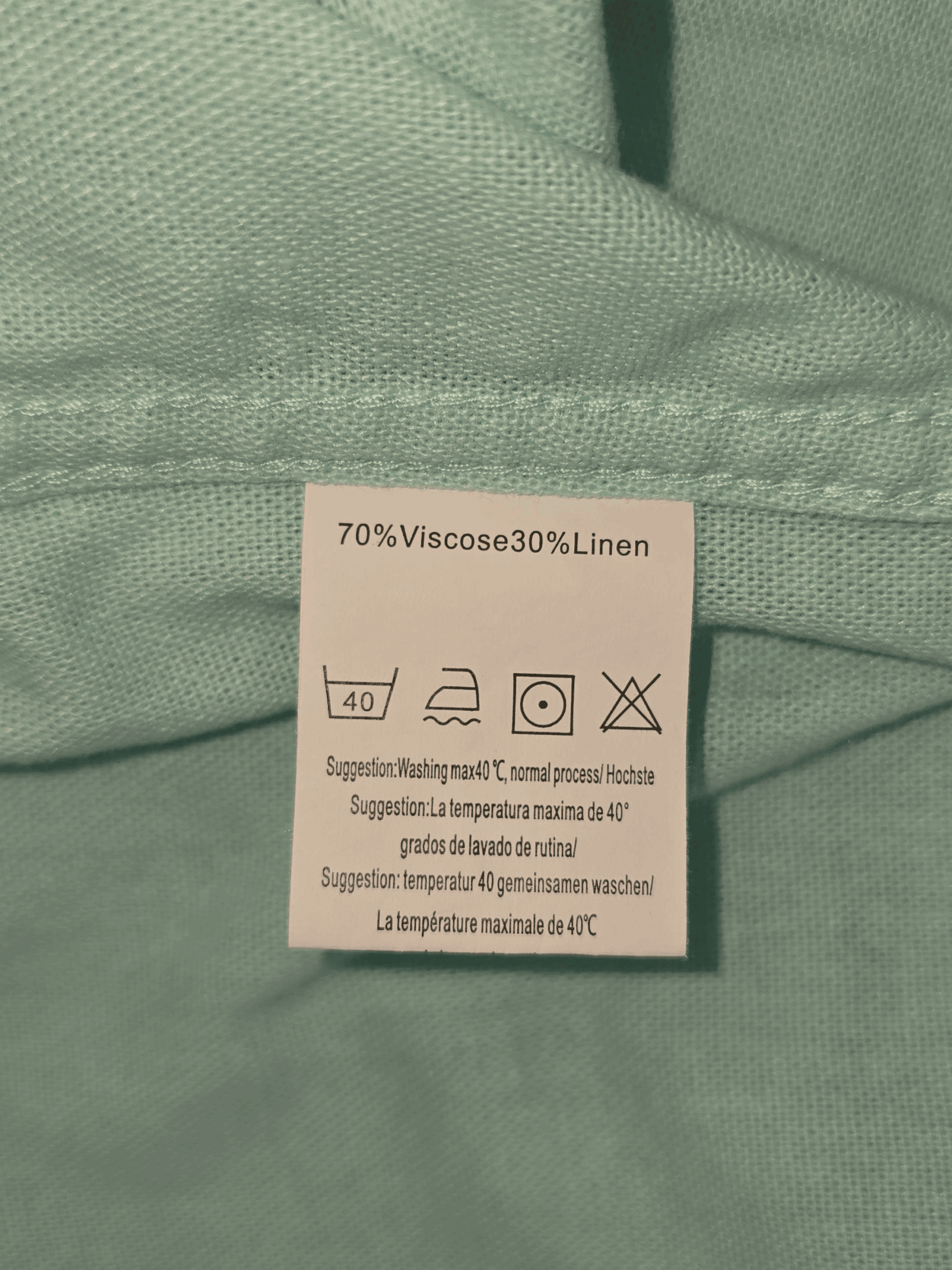 Material content tag listing linen and cotton blend for Coofandy mint green short sleeve button-up shirt.