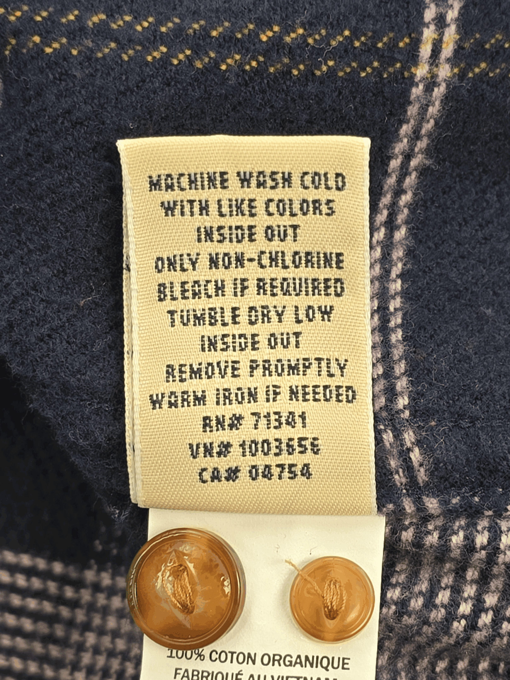 Garment care instruction tag from L.L. Bean navy, lilac, and yellow plaid flannel shirt women’s plus size 3X