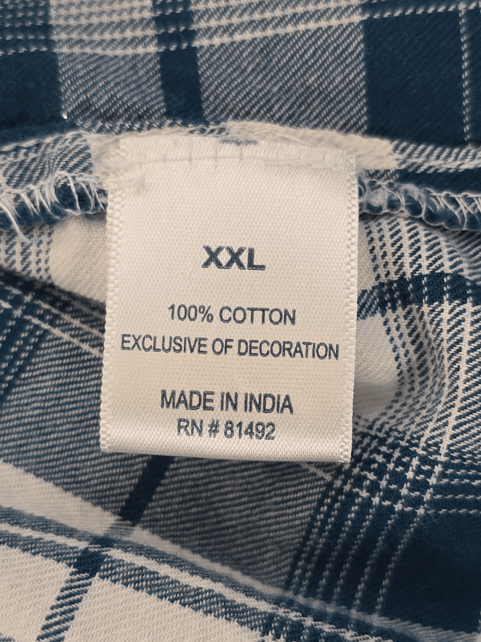Clothing label showing size XXL, 100% cotton, made in India.