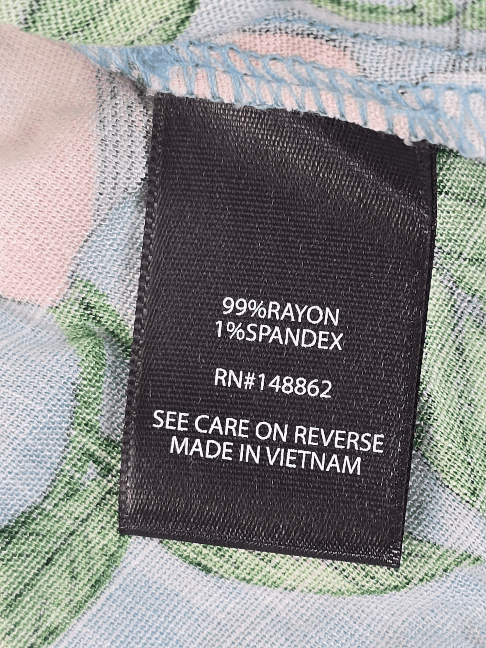 Clothing label showing fabric composition and care instructions.