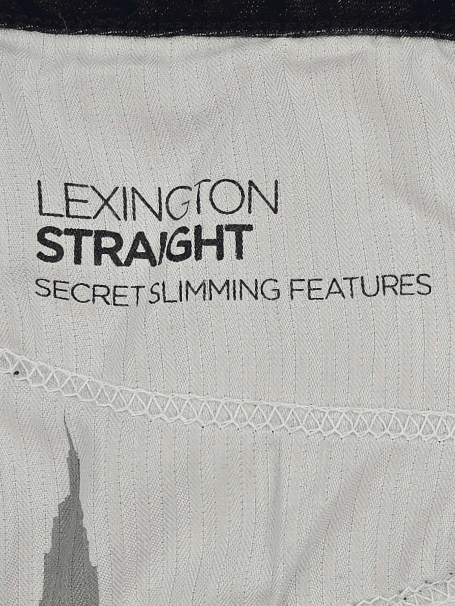 Close-up of a fabric label with text about slimming features.