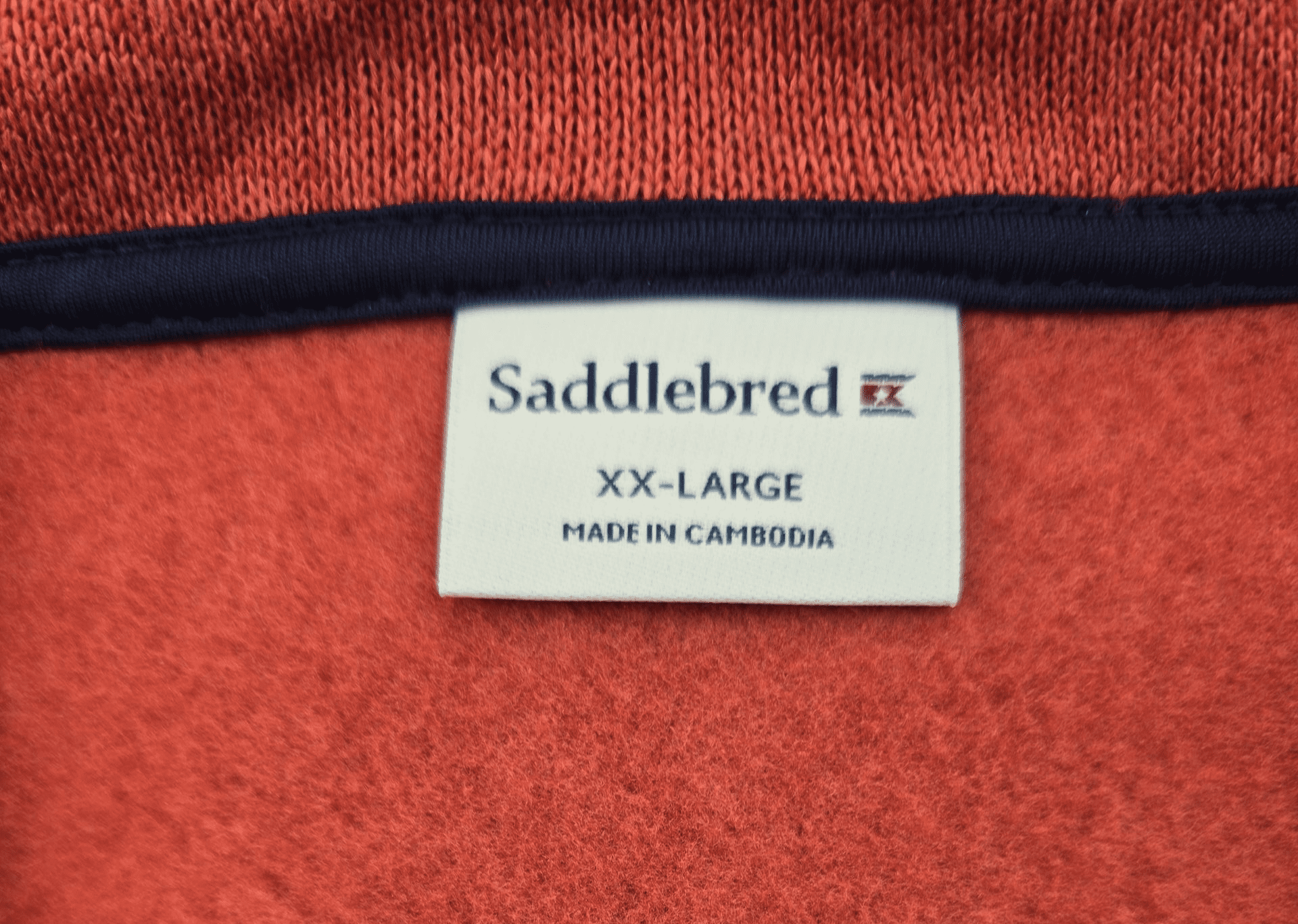 Saddlebred brand and size tag on rust quarter-zip knit pullover in men’s size XXL.