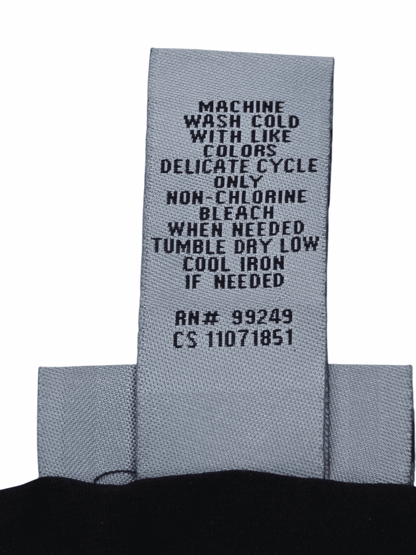 Clothing care label with washing and ironing instructions.