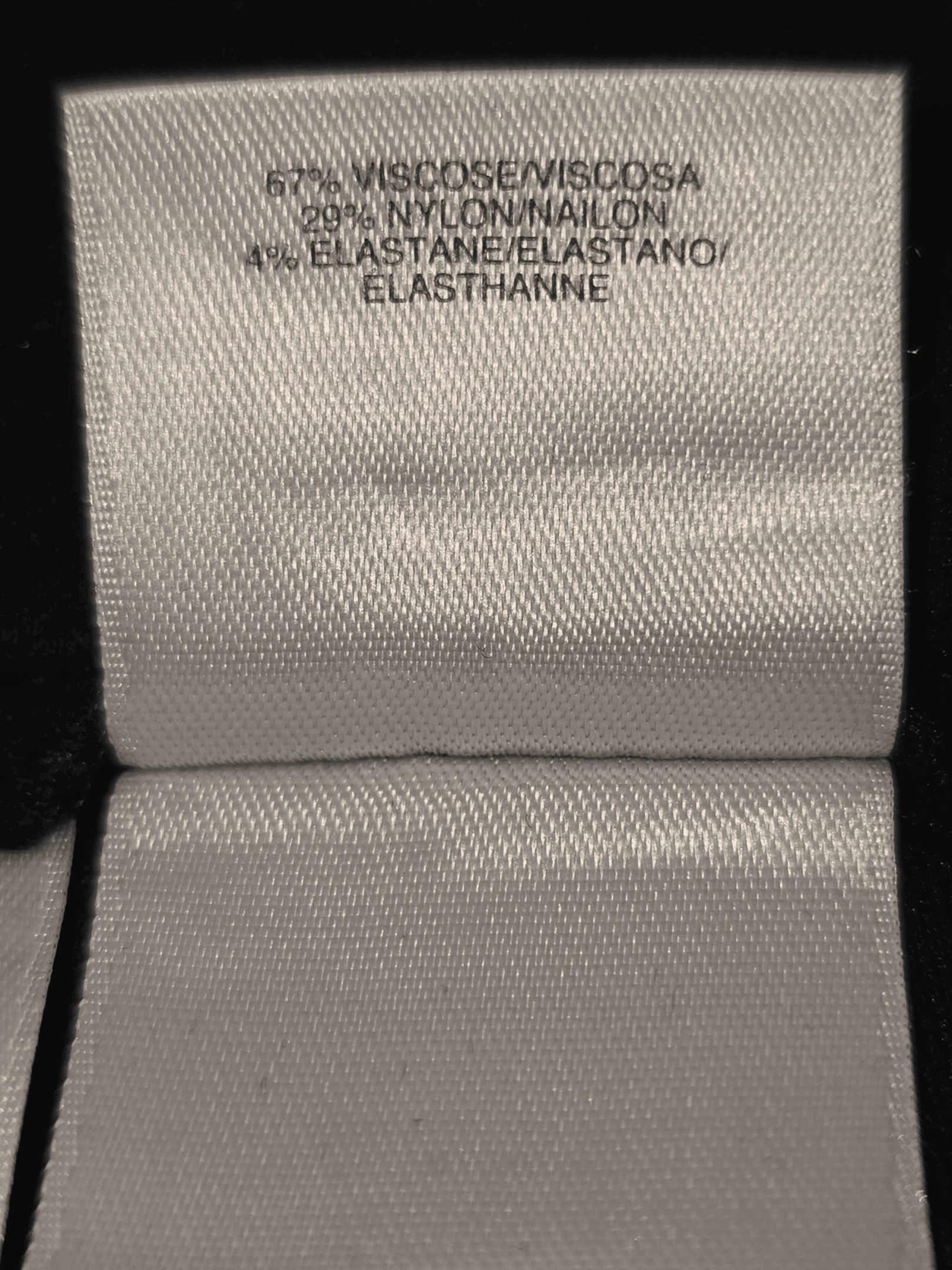 Close-up of waistband and fabric texture on Anne Klein black knit stretch tapered leg slacks women’s size 14