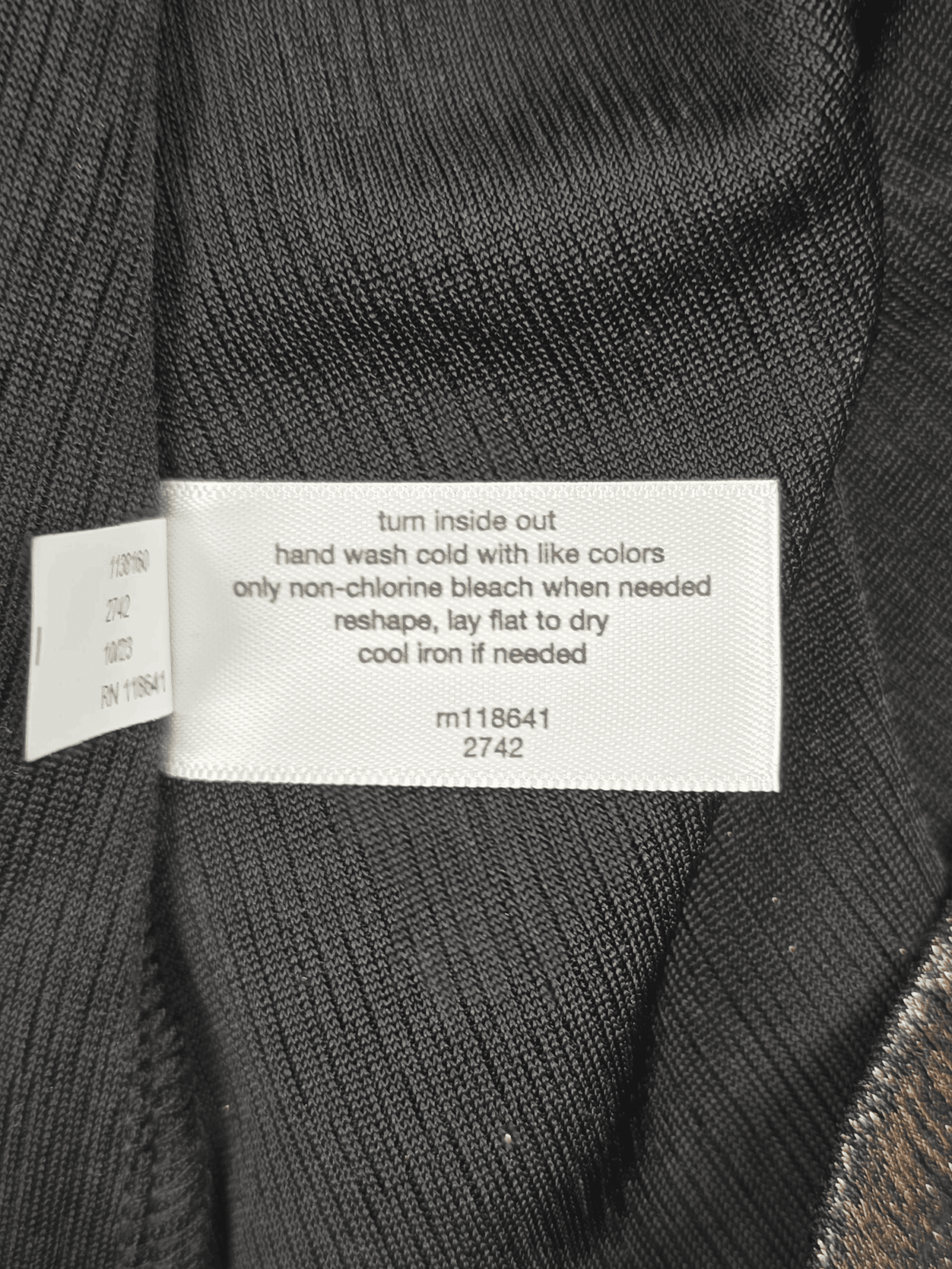 Garment care instruction tag from Lane Bryant shimmering copper pullover top women’s plus size 22/24