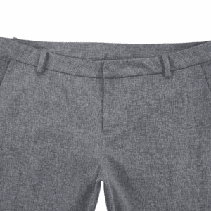 Close-up of gray dress pants with belt loops and front pockets.