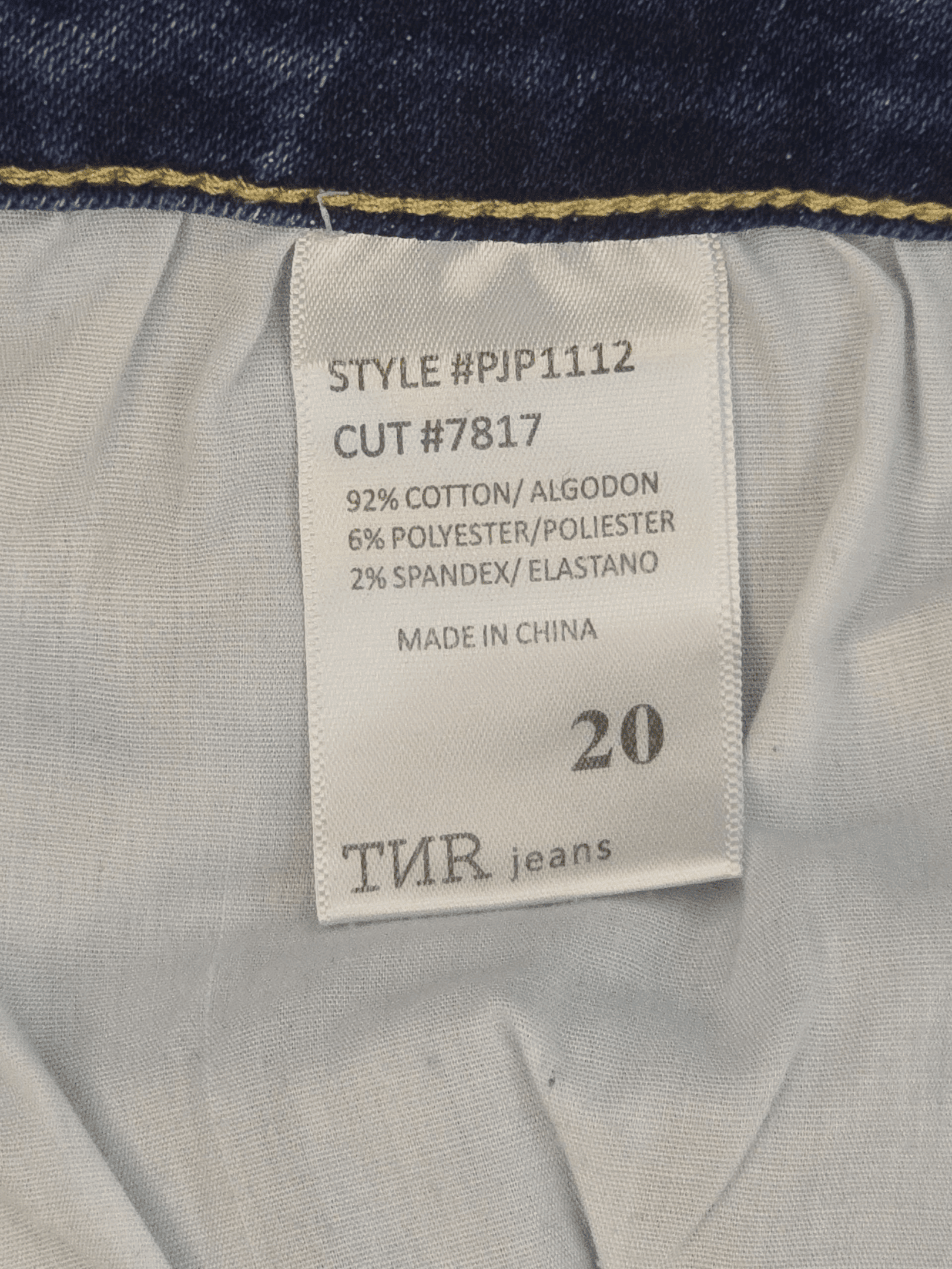 Fabric content tag from TNR blue distressed tapered jeans women’s plus size 20