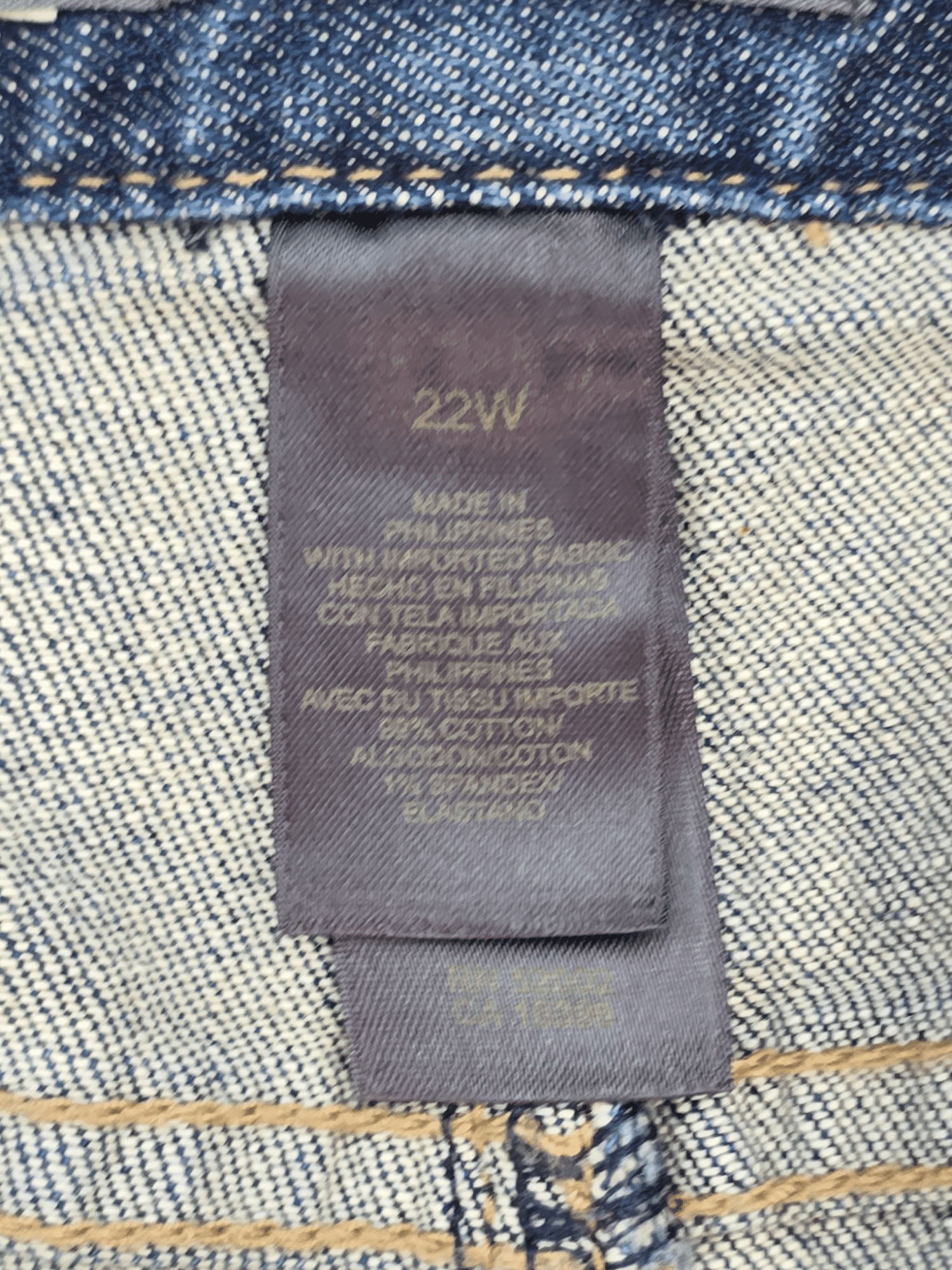 Material content tag listing cotton, polyester, and spandex blend for Liz Claiborne cropped denim pants.