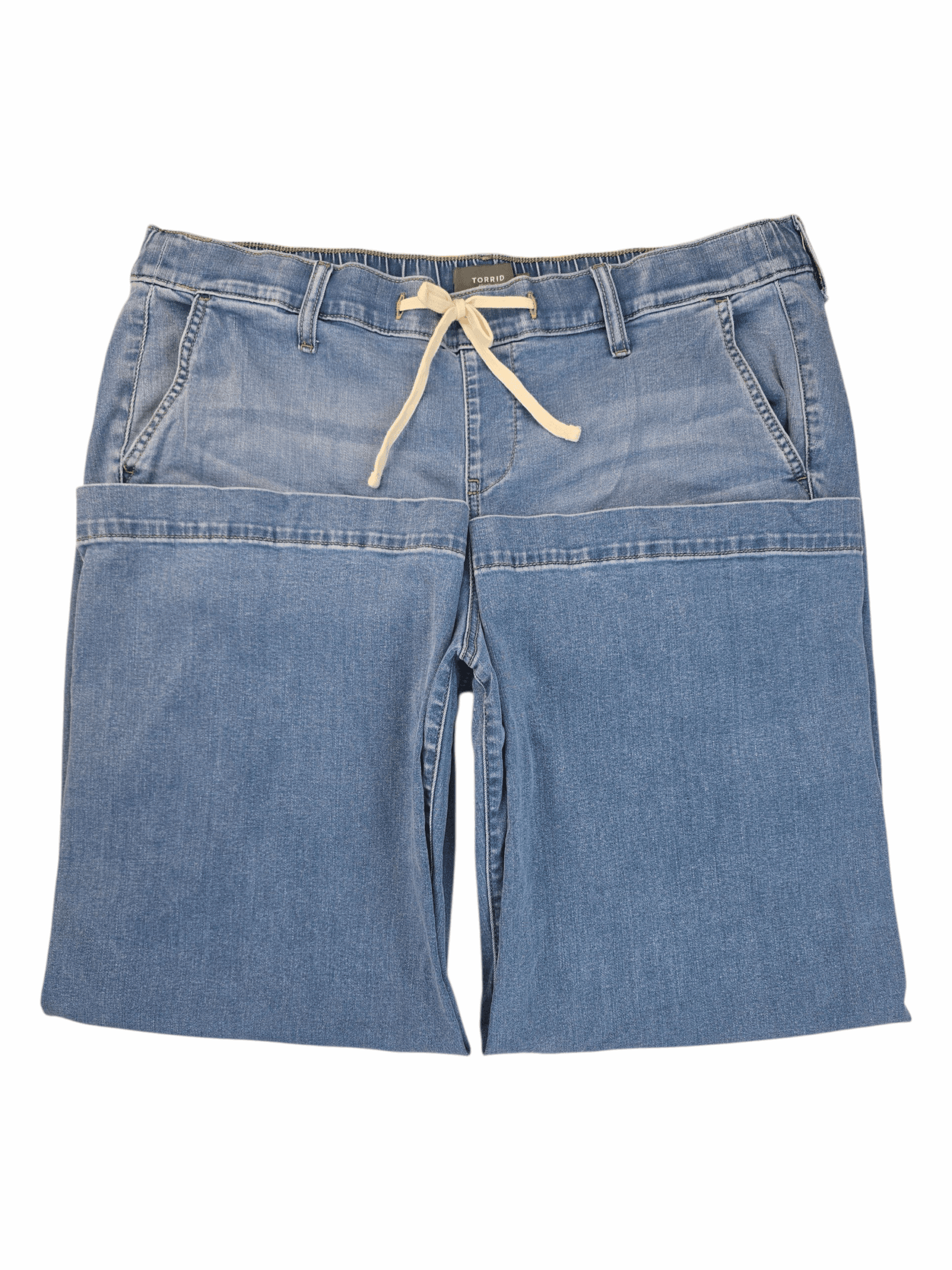 Close-up of Torrid light blue denim ankle pants front showing pull-on closure and fabric texture.