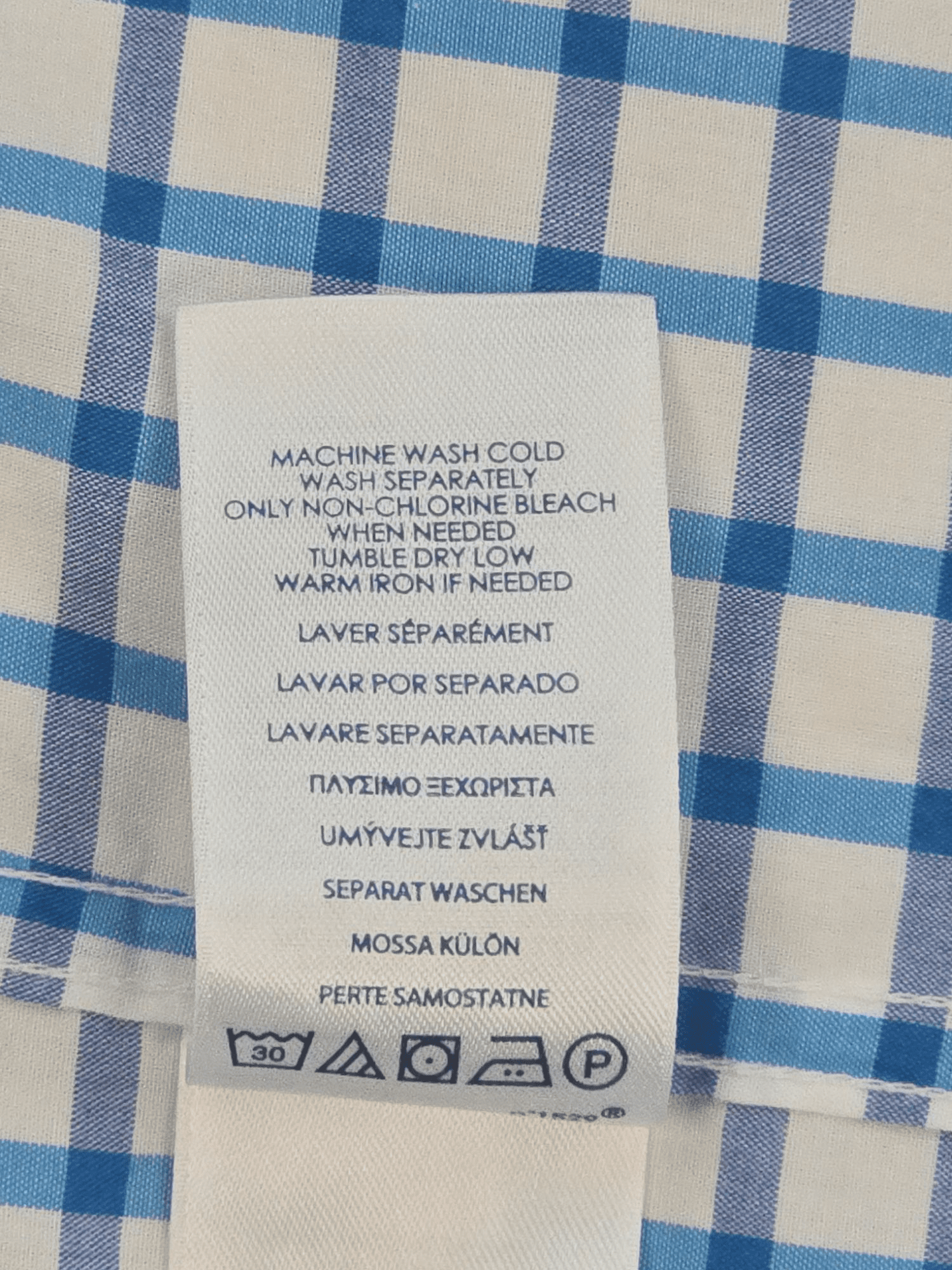 Garment care tag for Chaps Easy Care blue checked short sleeve shirt showing washing and drying directions.