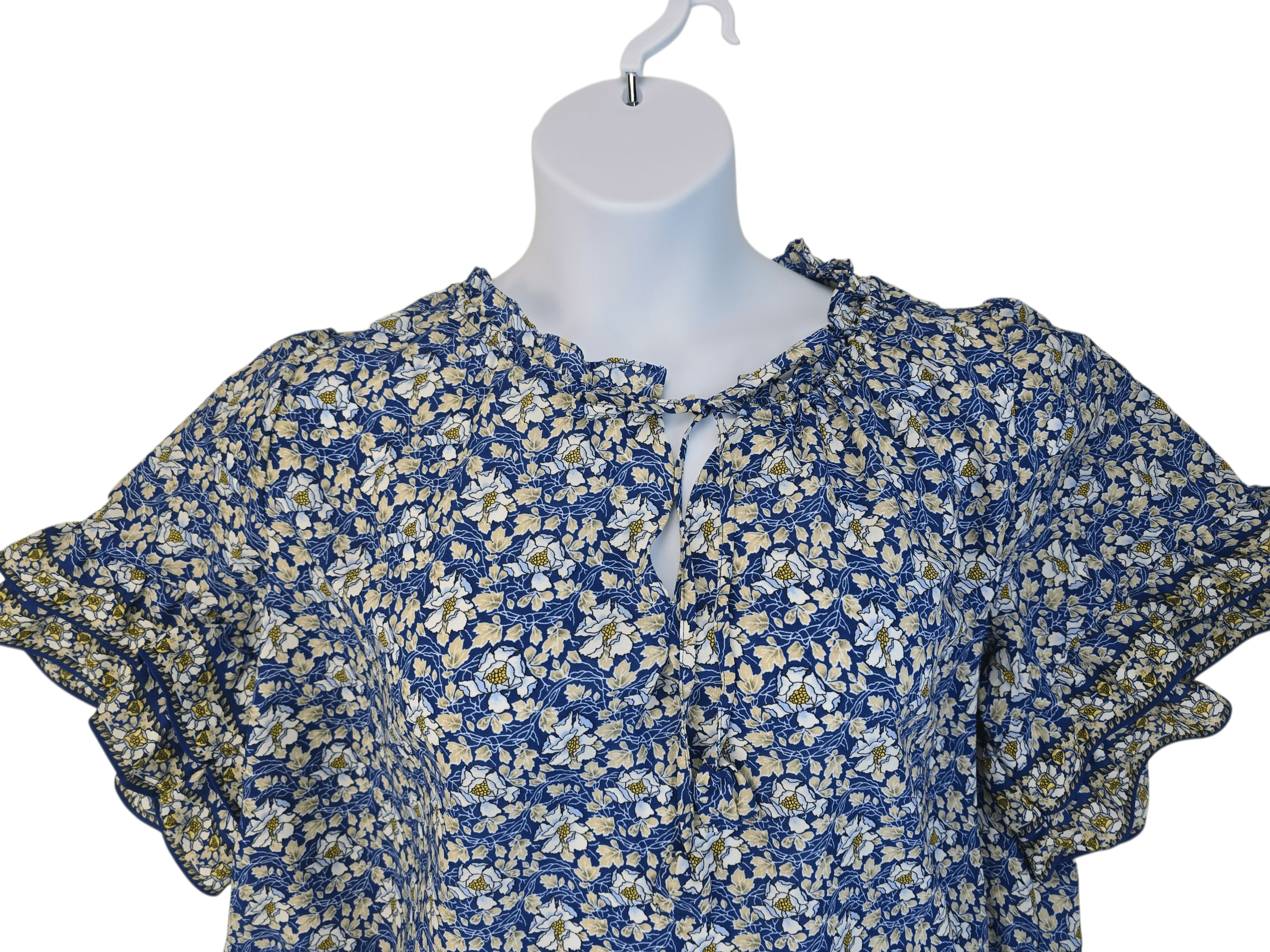 Blue floral dress with buttons on a mannequin.