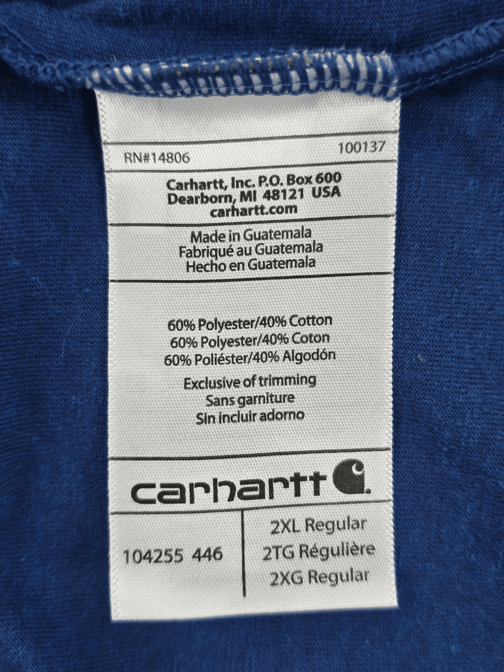 Clothing label with fabric composition and care instructions in multiple languages.