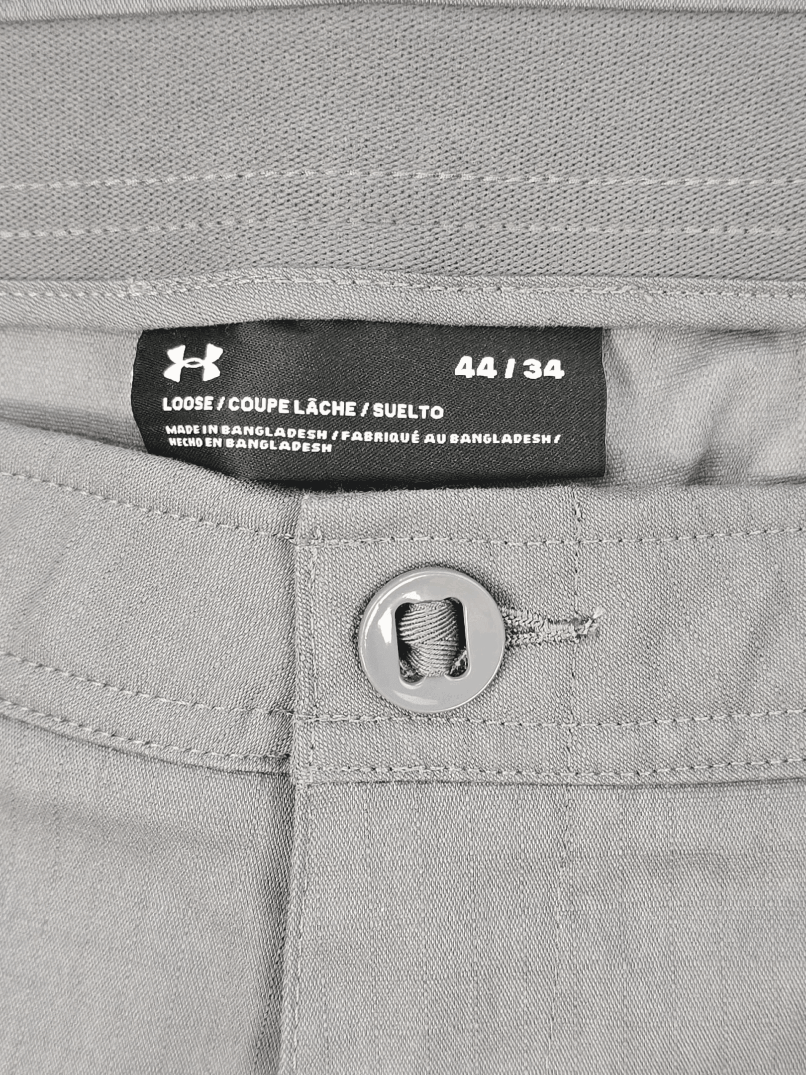 Close-up of Under Armour brand and size 44 tag on Storm Quick-Dry ripstop pants
