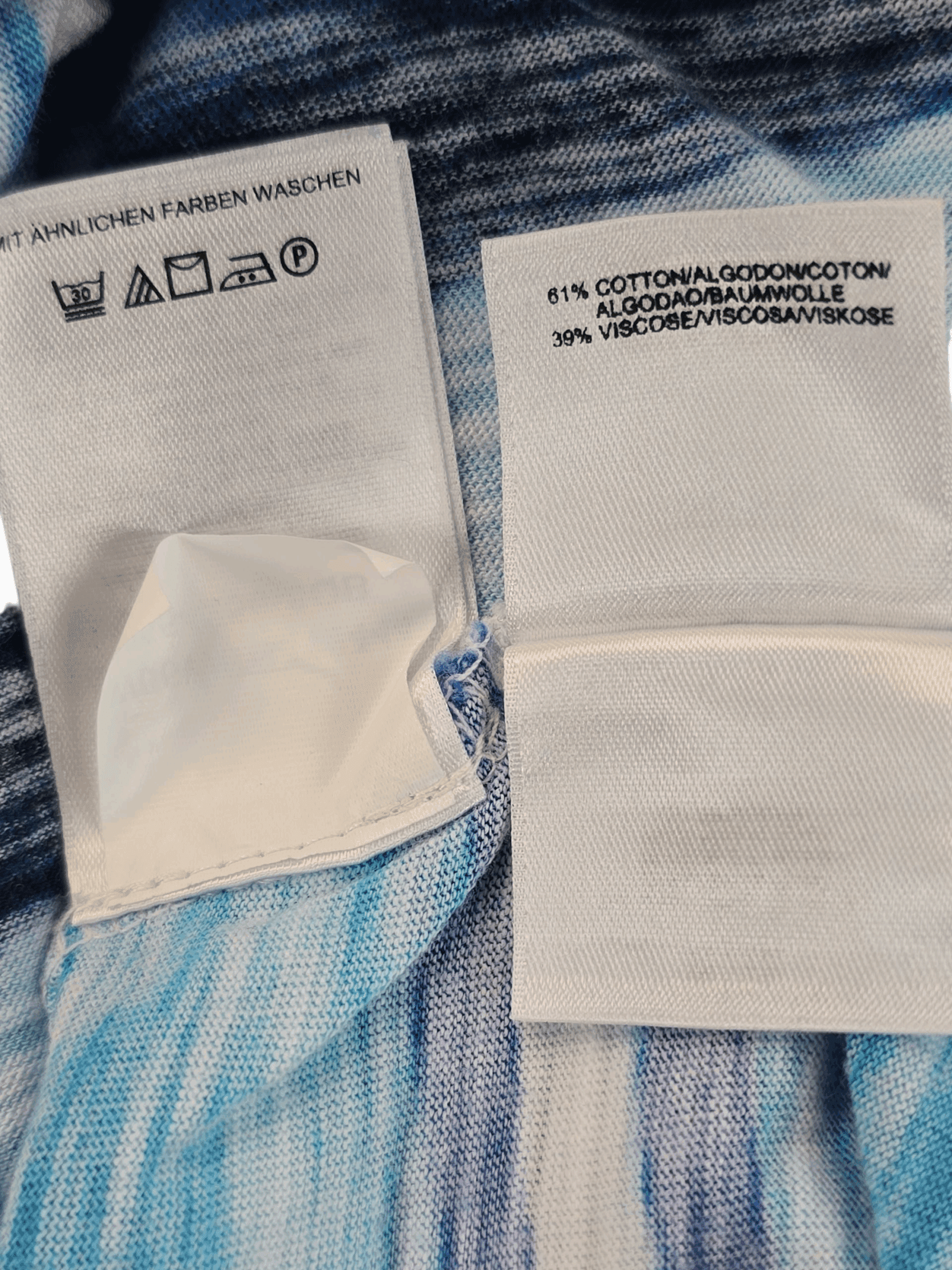 Material content tag listing cotton and spandex blend for Jones New York Sport Woman blue and yellow paint stroke pullover top.