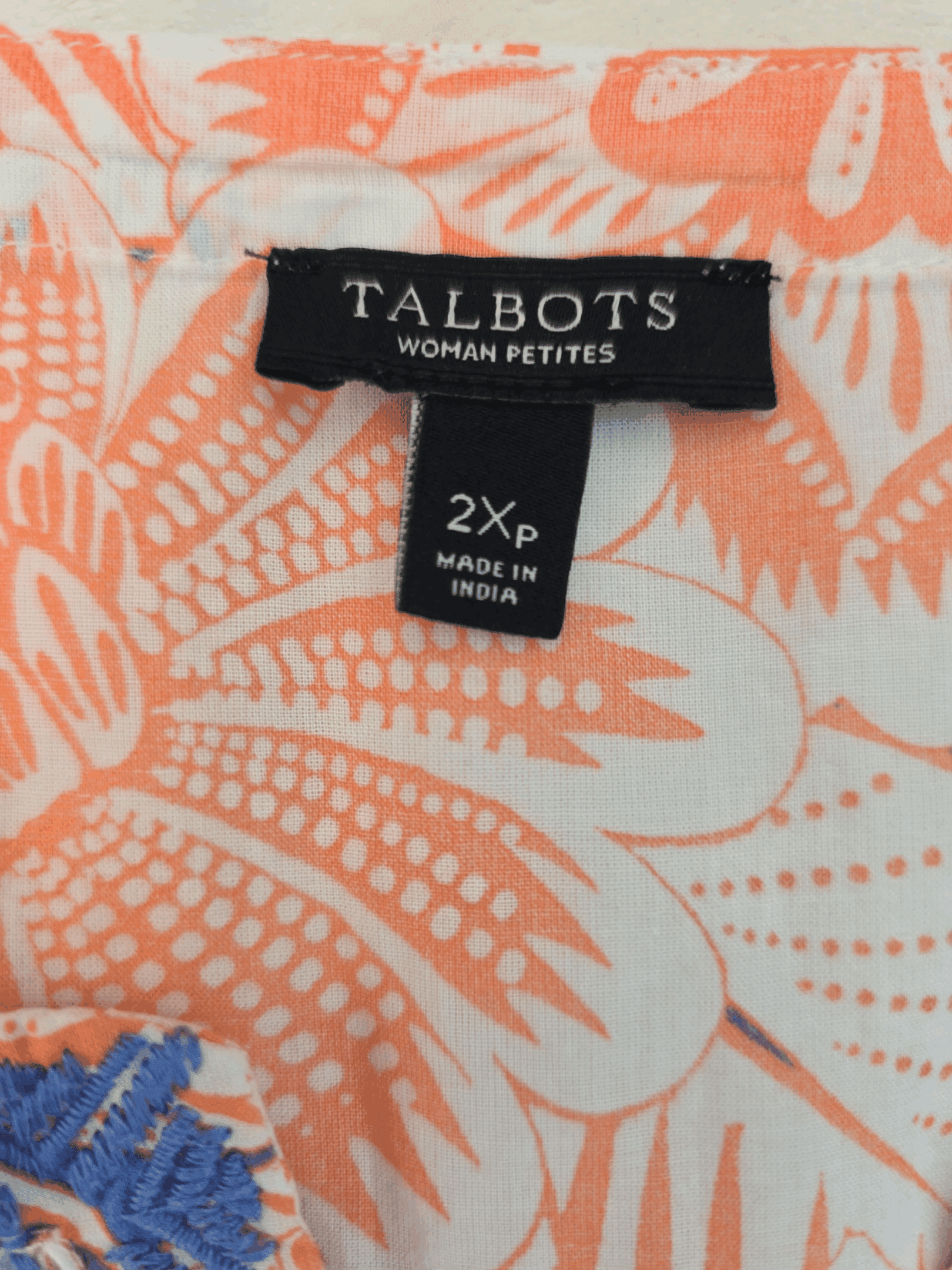 Clothing label of Talbots with size 2X and floral fabric.