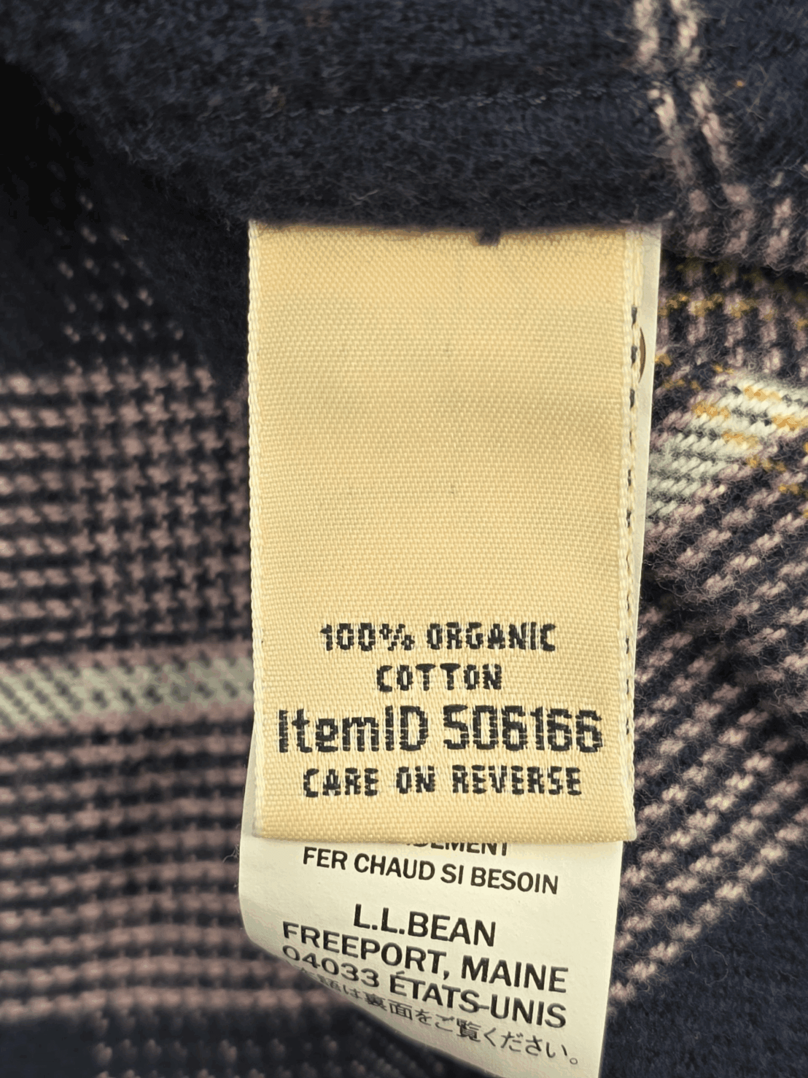 Fabric content tag from L.L. Bean navy, lilac, and yellow plaid flannel shirt women’s plus size 3X