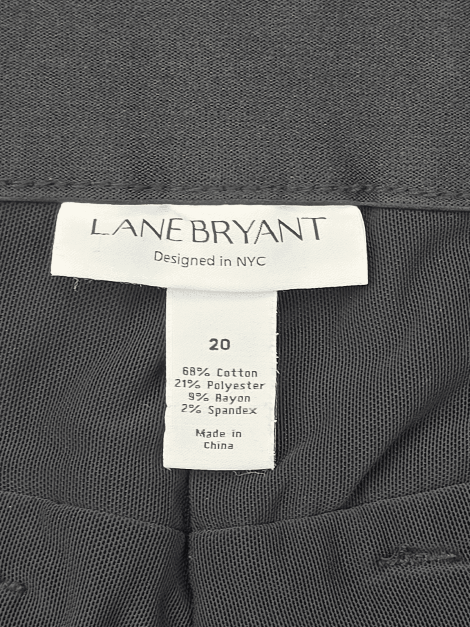 Material content tag listing cotton, polyester, and spandex blend for Lane Bryant black denim ankle pants.