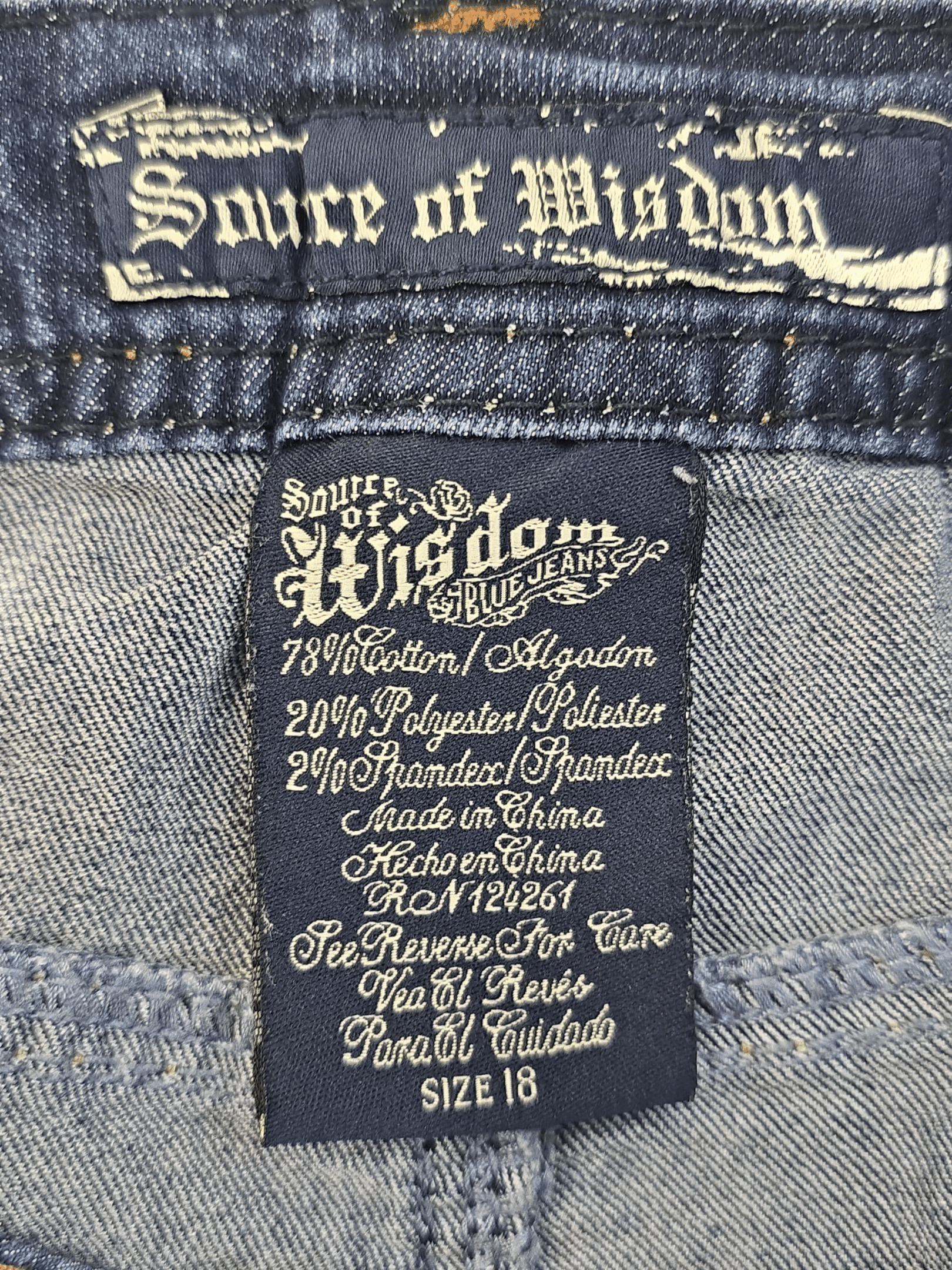 Clothing label with detailed fabric composition and brand name Source of Wisdom.