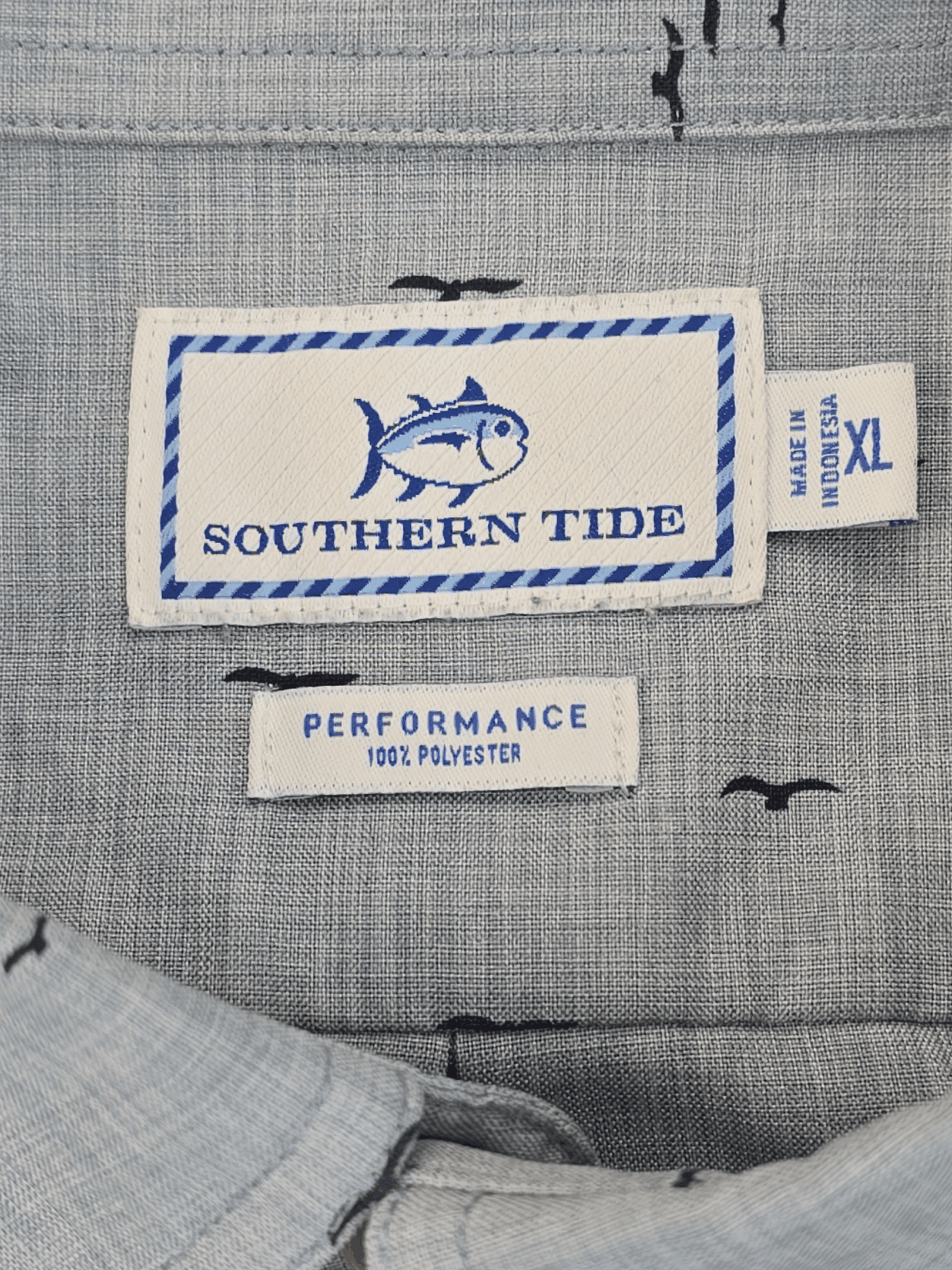Close-up of Southern Tide clothing labels on a textured fabric.