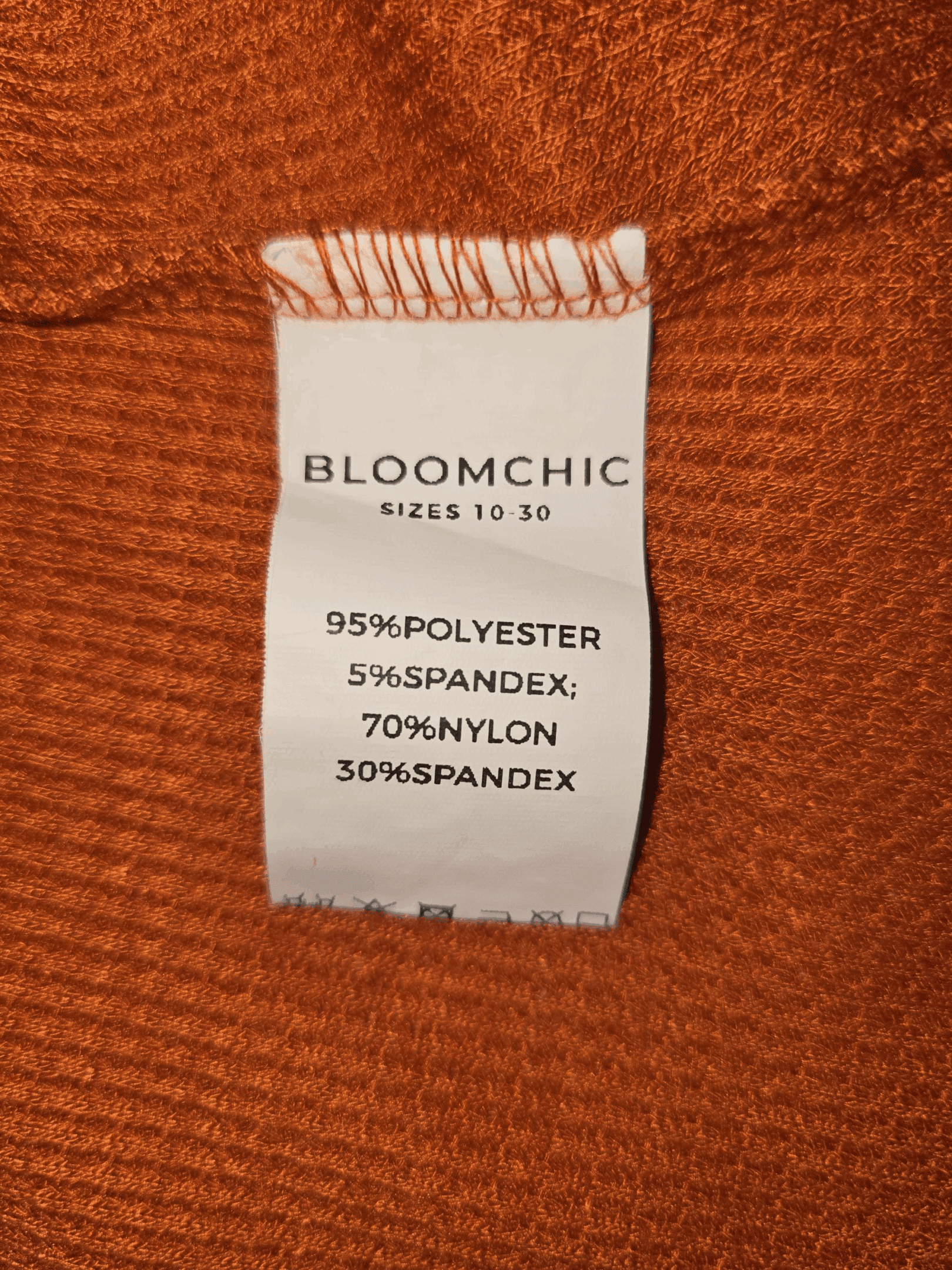 Clothing label showing fabric composition of a Bloomchic garment.