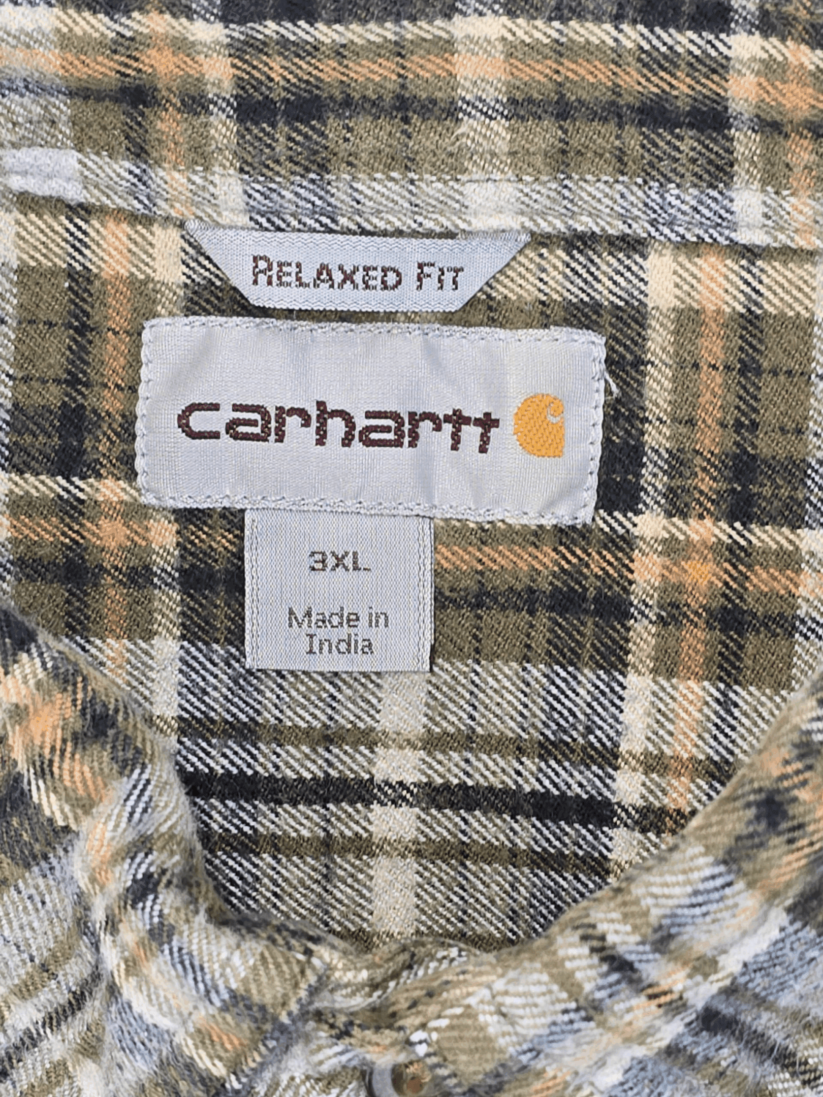 Close-up of a Carhartt shirt label showing size 3XL and relaxed fit.